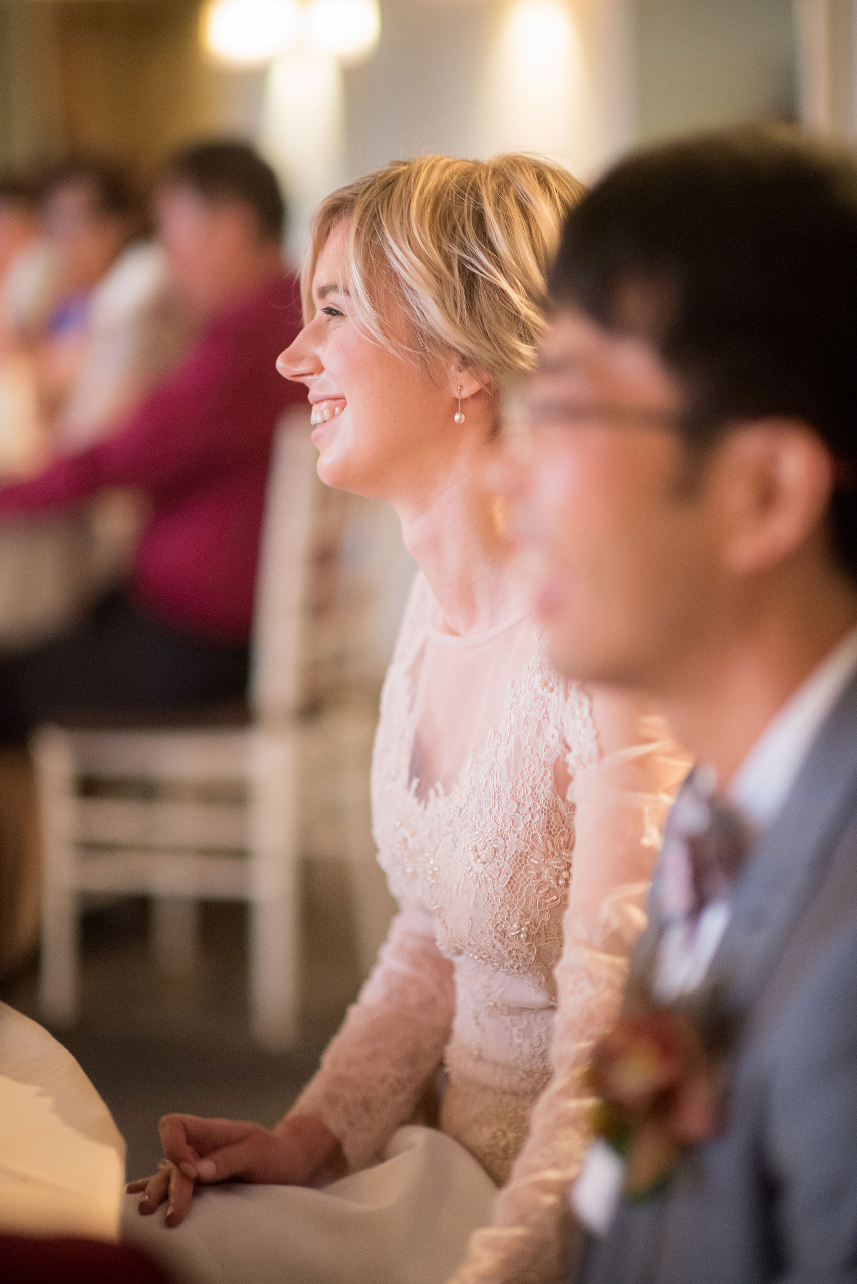 Mikkel Paige Photography photos of a wedding at Crabtree Kittle's House. Candid picture of the bride watching her father's speech.