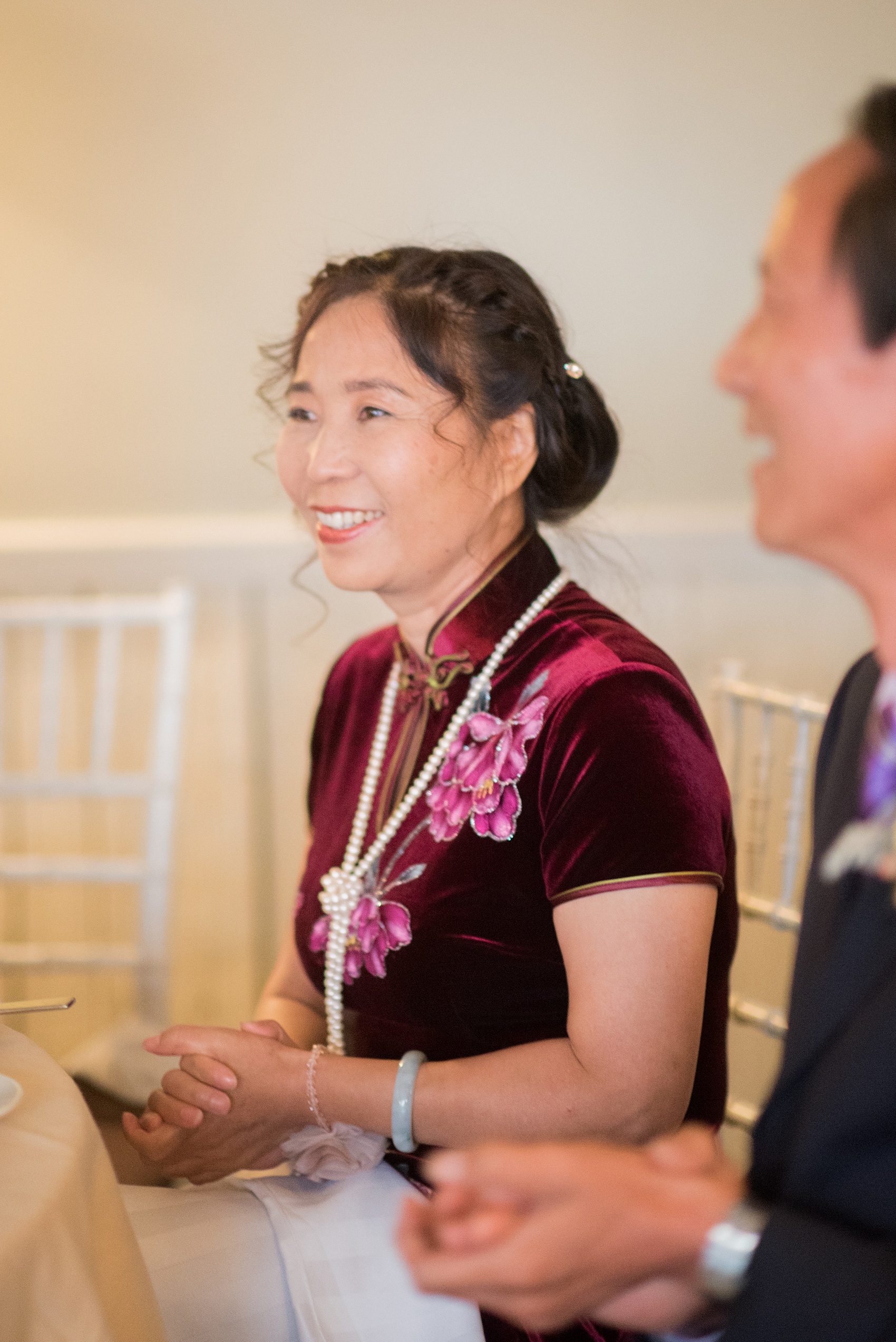 Mikkel Paige Photography photos of a wedding at Crabtree Kittle's House. Candid picture of the mother of the groom during the reception.