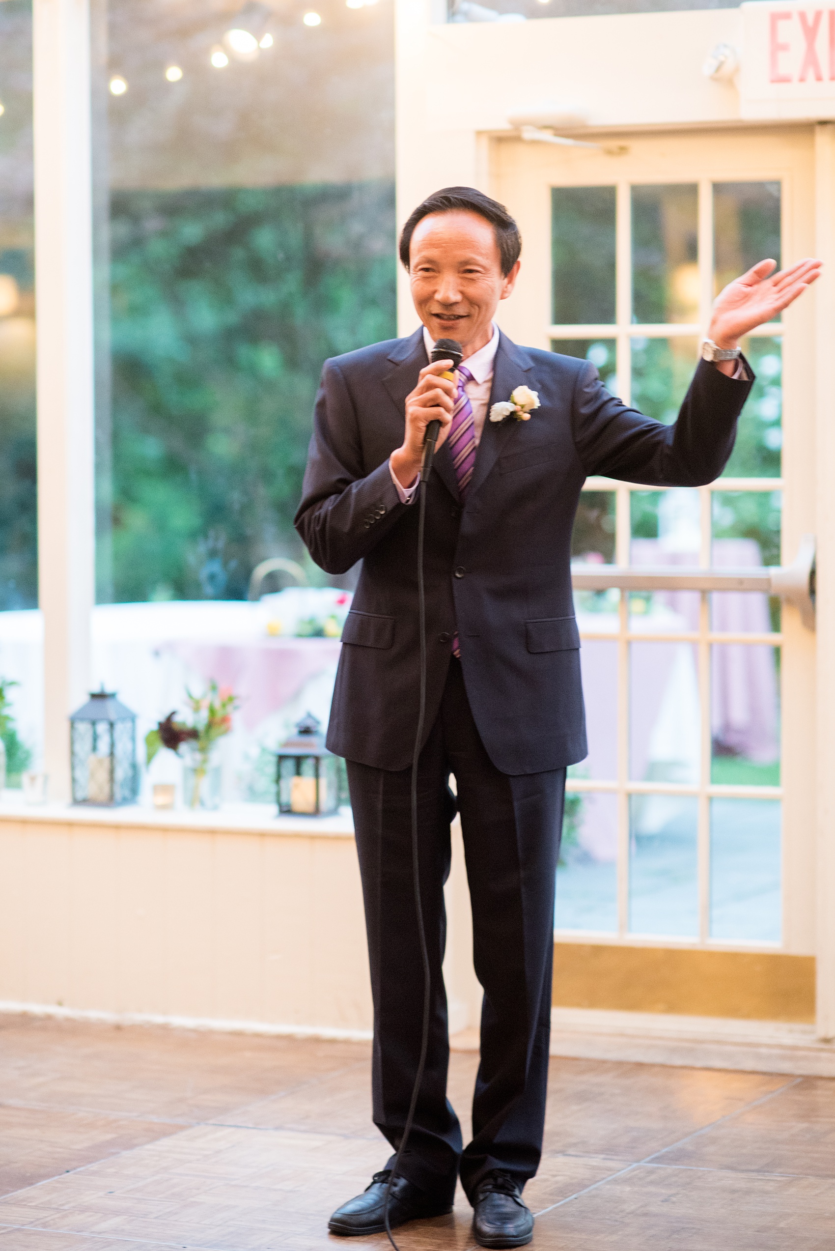 Mikkel Paige Photography photos of a wedding at Crabtree Kittle's House. Candid picture of the groom's father giving a speech in Chinese during the reception.