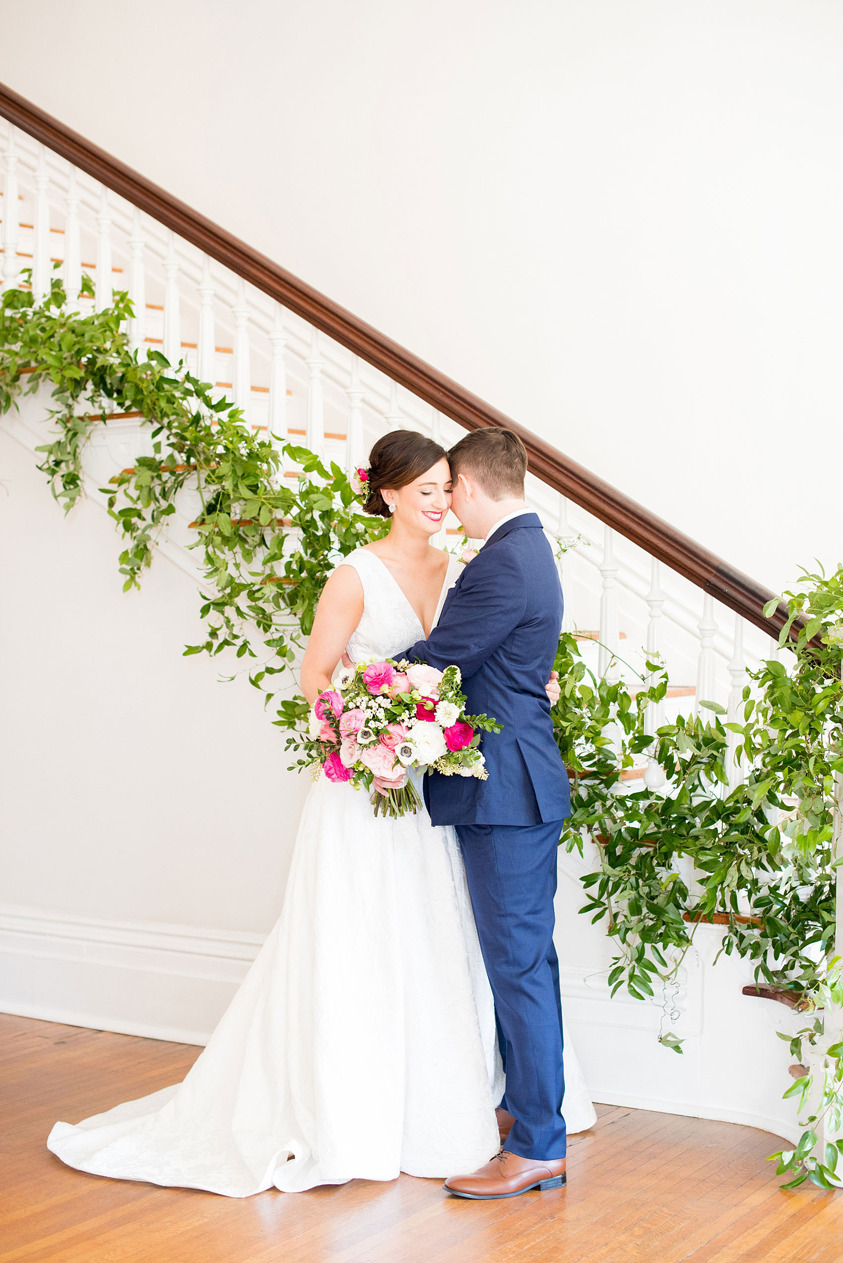 Mikkel Paige Photography pictures from a wedding at Merrimon-Wynne House in Raleigh, NC. Photo of the bride and groom near the staircase of the historic home.