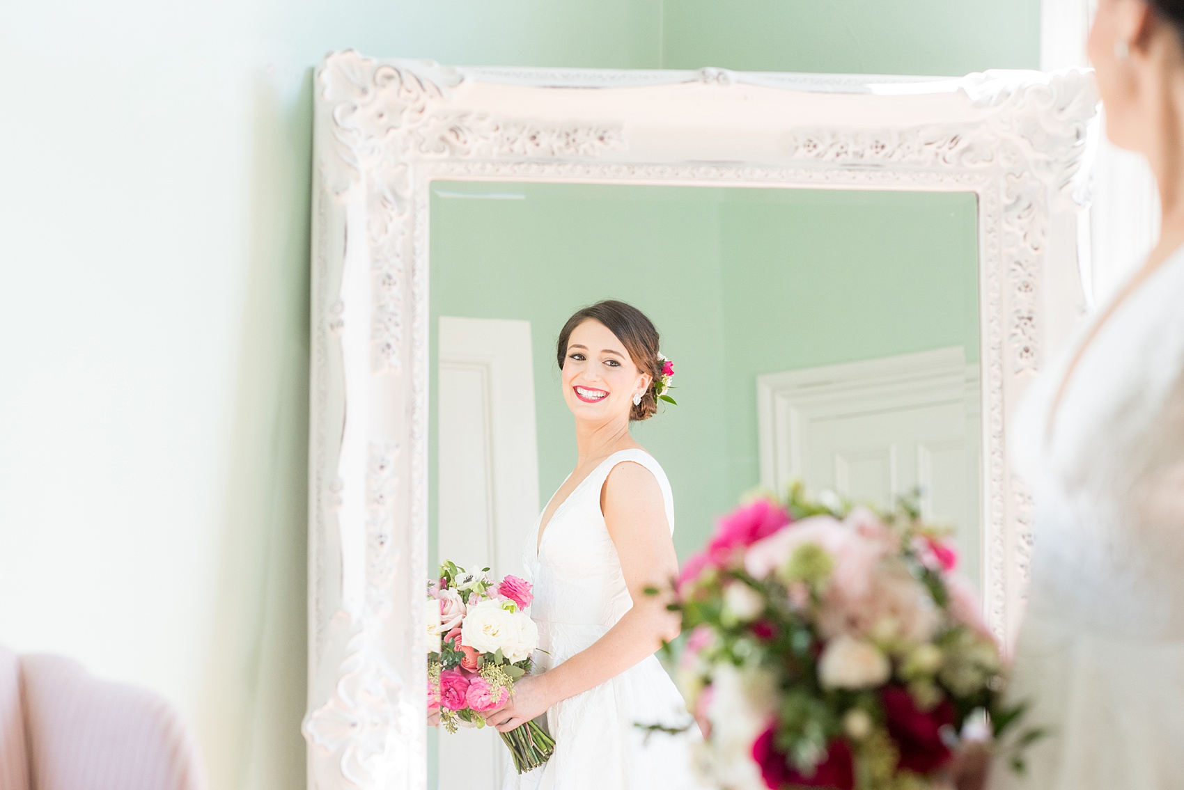 Mikkel Paige Photography pictures from a wedding at Merrimon-Wynne House in Raleigh, NC. Photo of the bride reflecting in a mirror in the bridal suite.