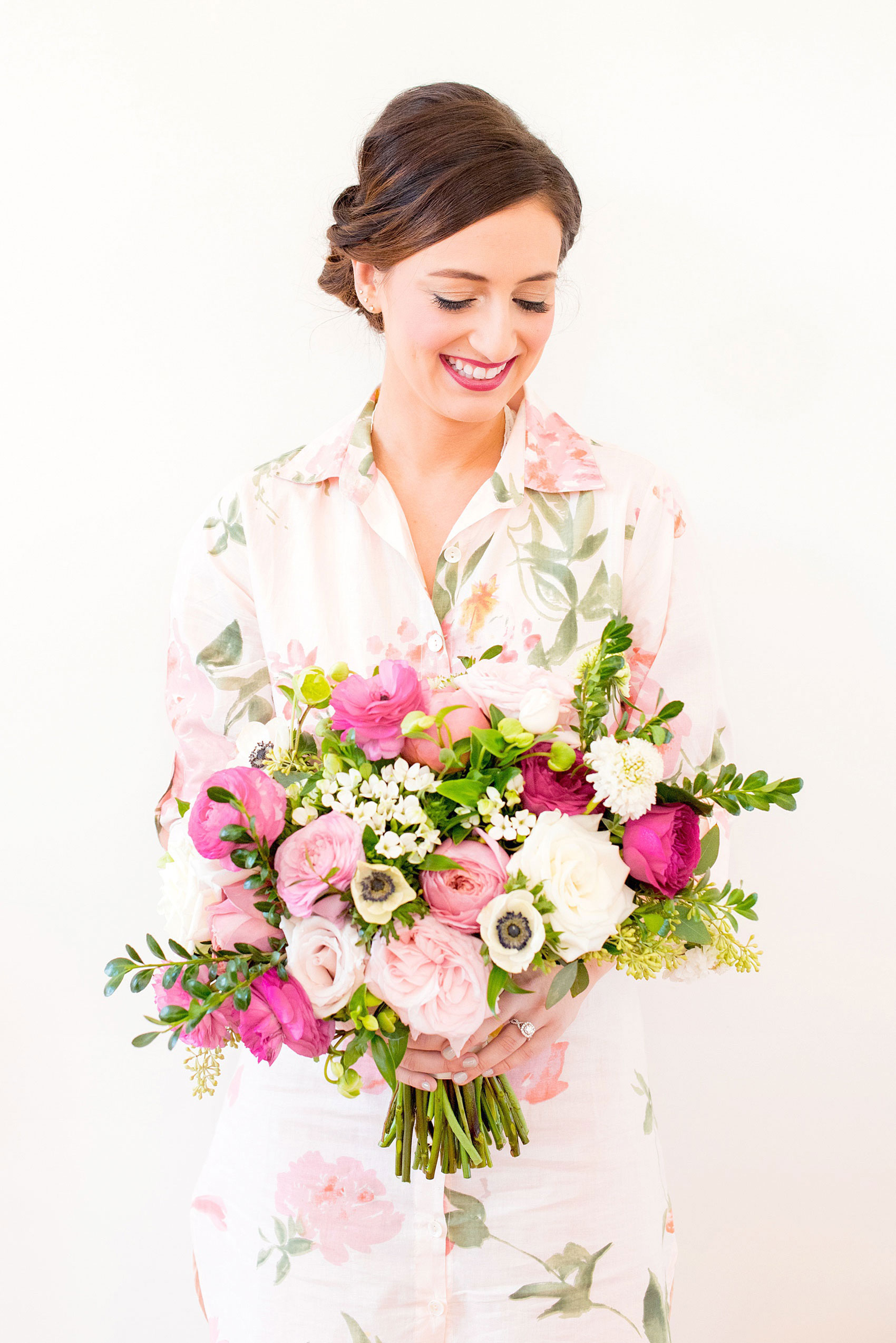 Mikkel Paige Photography pictures from a wedding at Merrimon-Wynne House in Raleigh, NC. Photo of the bride holding her colorful pink and green bouquet, created by Eclectic Sage.