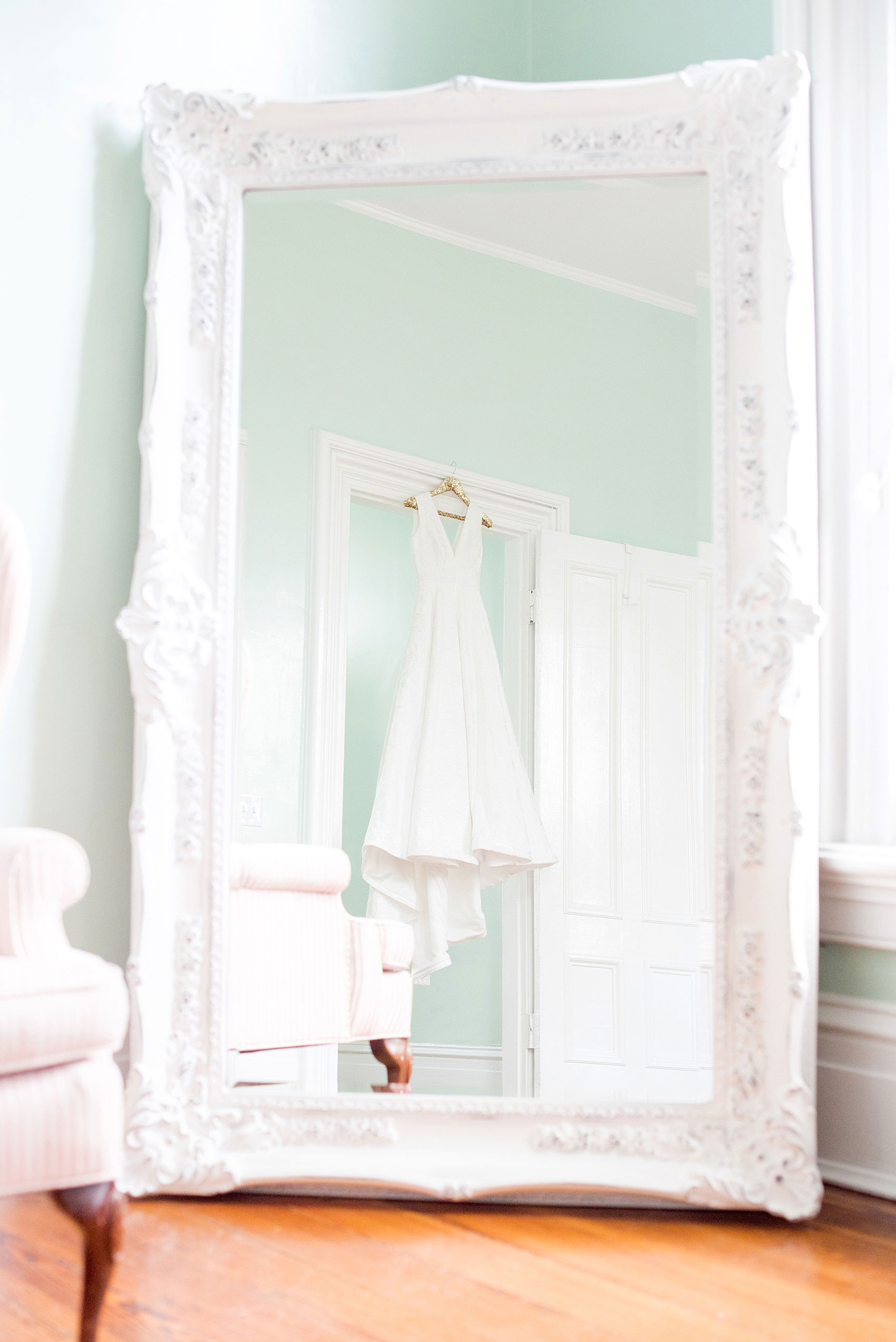 Mikkel Paige Photography pictures from a wedding at Merrimon-Wynne House in Raleigh, NC. Photo of the bride's Kate McDonald dress reflecting in a mirror in the bridal suite.