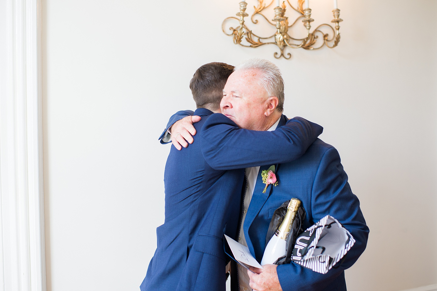 Mikkel Paige Photography pictures from a wedding at Merrimon-Wynne House in Raleigh, NC. Photo of the groom hugging his father.