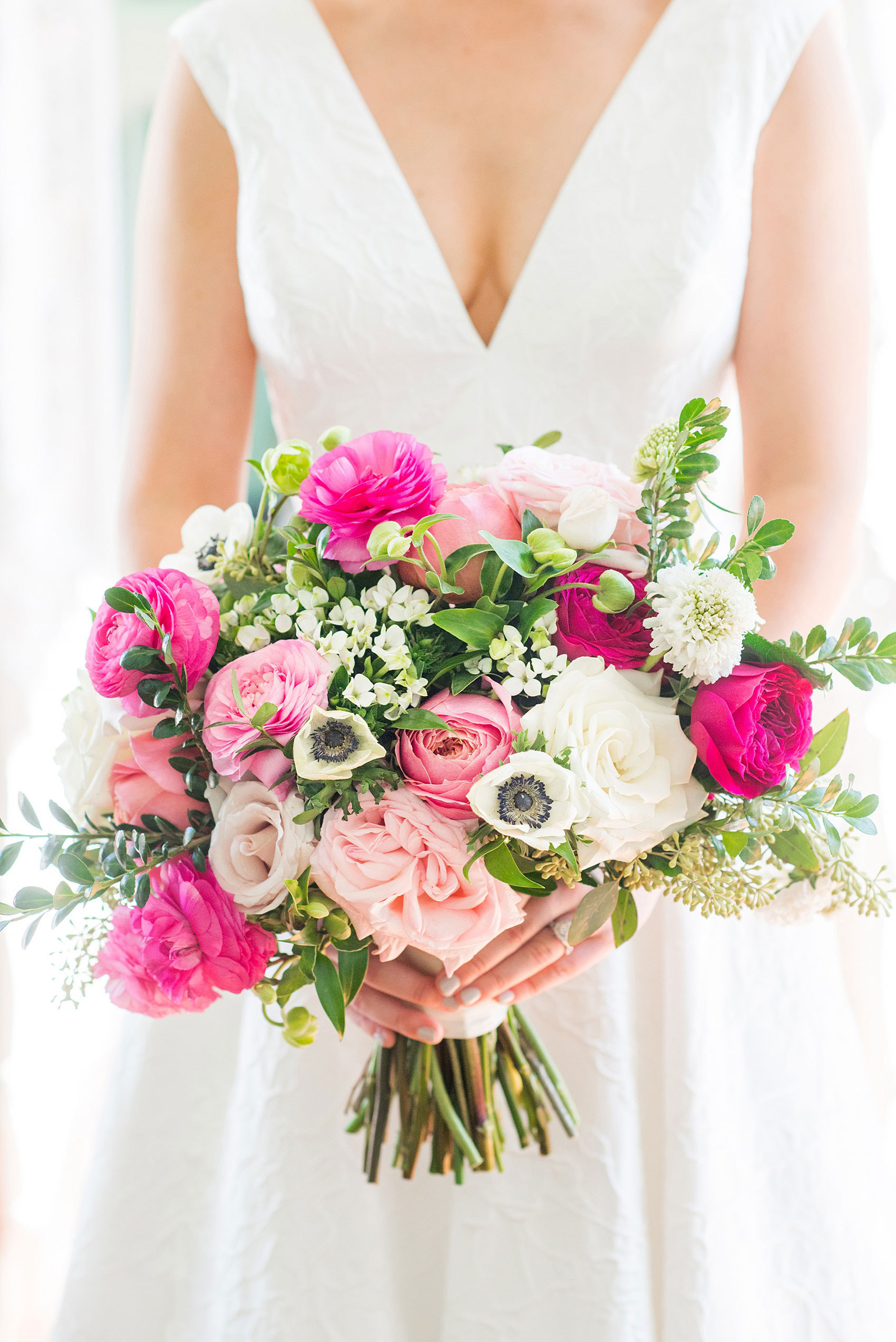 Mikkel Paige Photography pictures from a wedding at Merrimon-Wynne House in Raleigh, NC. Photo of the bride's colorful bouquet with light and hot pinks, white and greens created by Eclectic Sage.