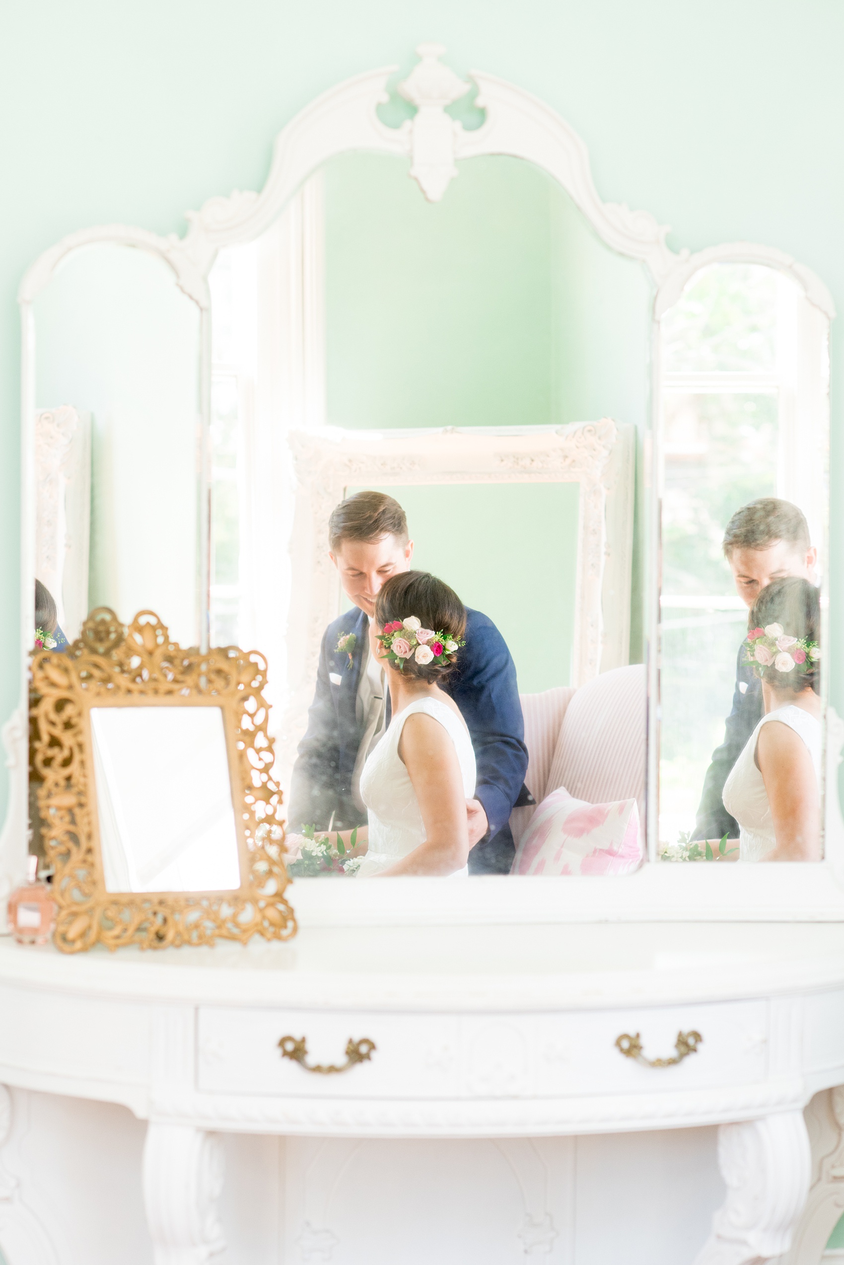 Mikkel Paige Photography pictures from a wedding at Merrimon-Wynne House in Raleigh, NC. Photo of the bride and groom in the mirror of the bridal suite.