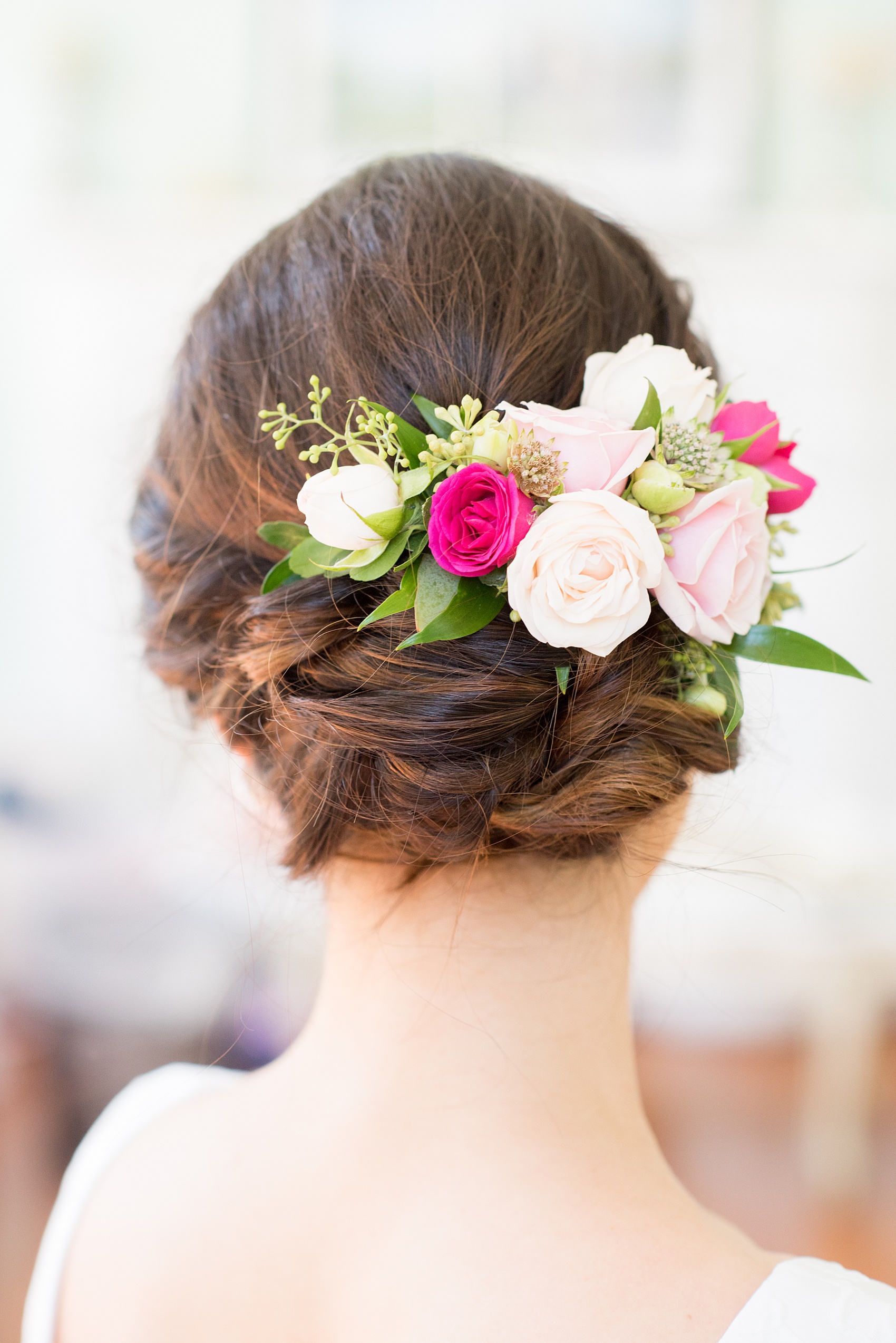 Mikkel Paige Photography pictures from a wedding at Merrimon-Wynne House in Raleigh, NC. Photo of the bride's up-do and flowers in her hair.