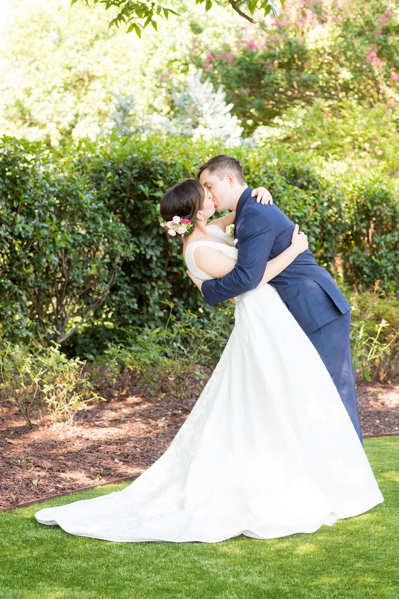 Mikkel Paige Photography pictures from a wedding at Merrimon-Wynne House in Raleigh, NC. Photo of the bride and groom kissing.