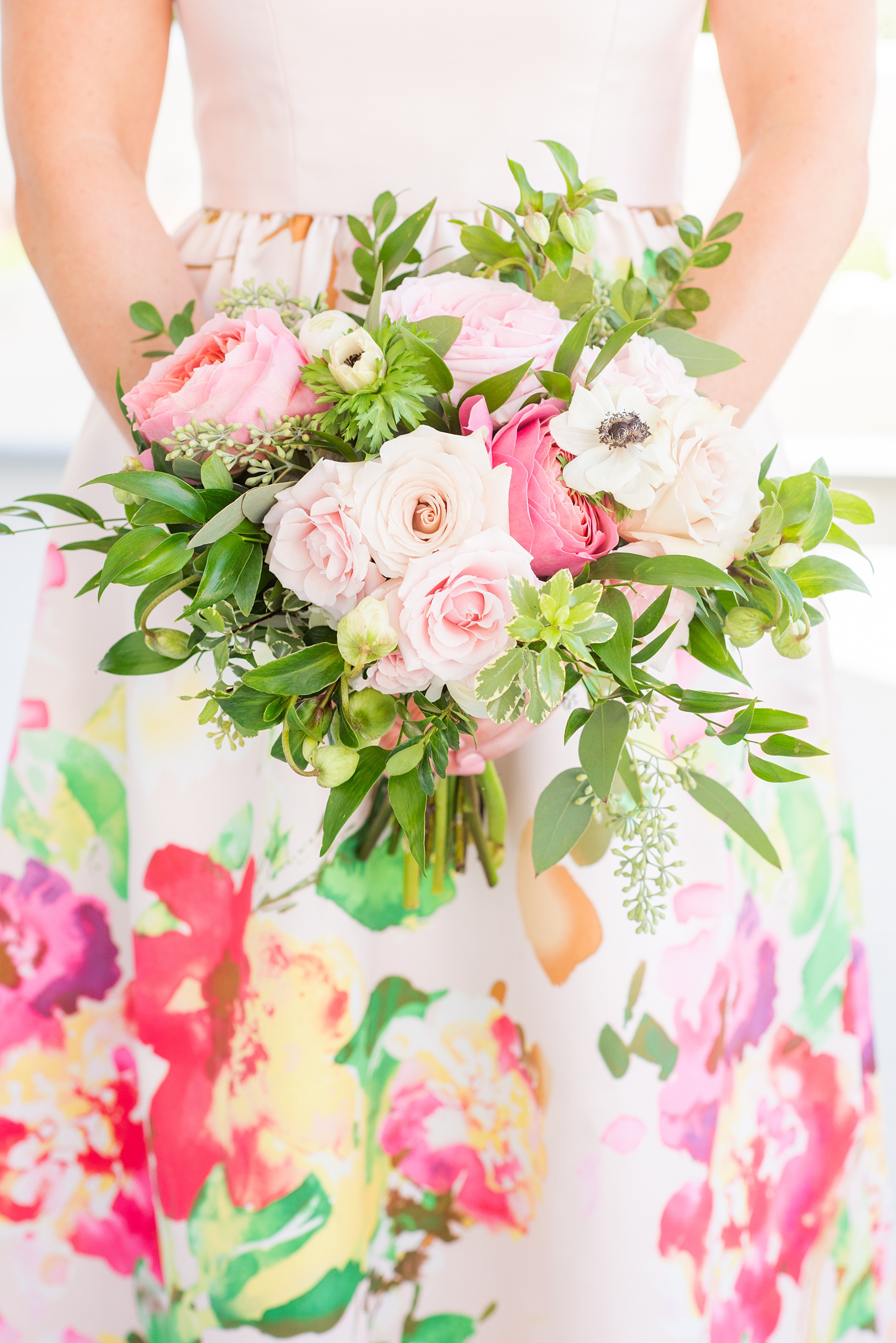 Mikkel Paige Photography pictures from a wedding at Merrimon-Wynne House in Raleigh, NC. Photo of the bridesmaids colorful bouquet with pinks and greens created by Eclectic Sage.