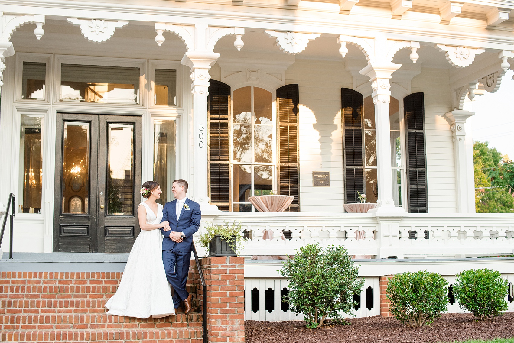 Mikkel Paige Photography pictures from a wedding at Merrimon-Wynne House in Raleigh, NC. Photo of the bride and groom in front of the historic home.