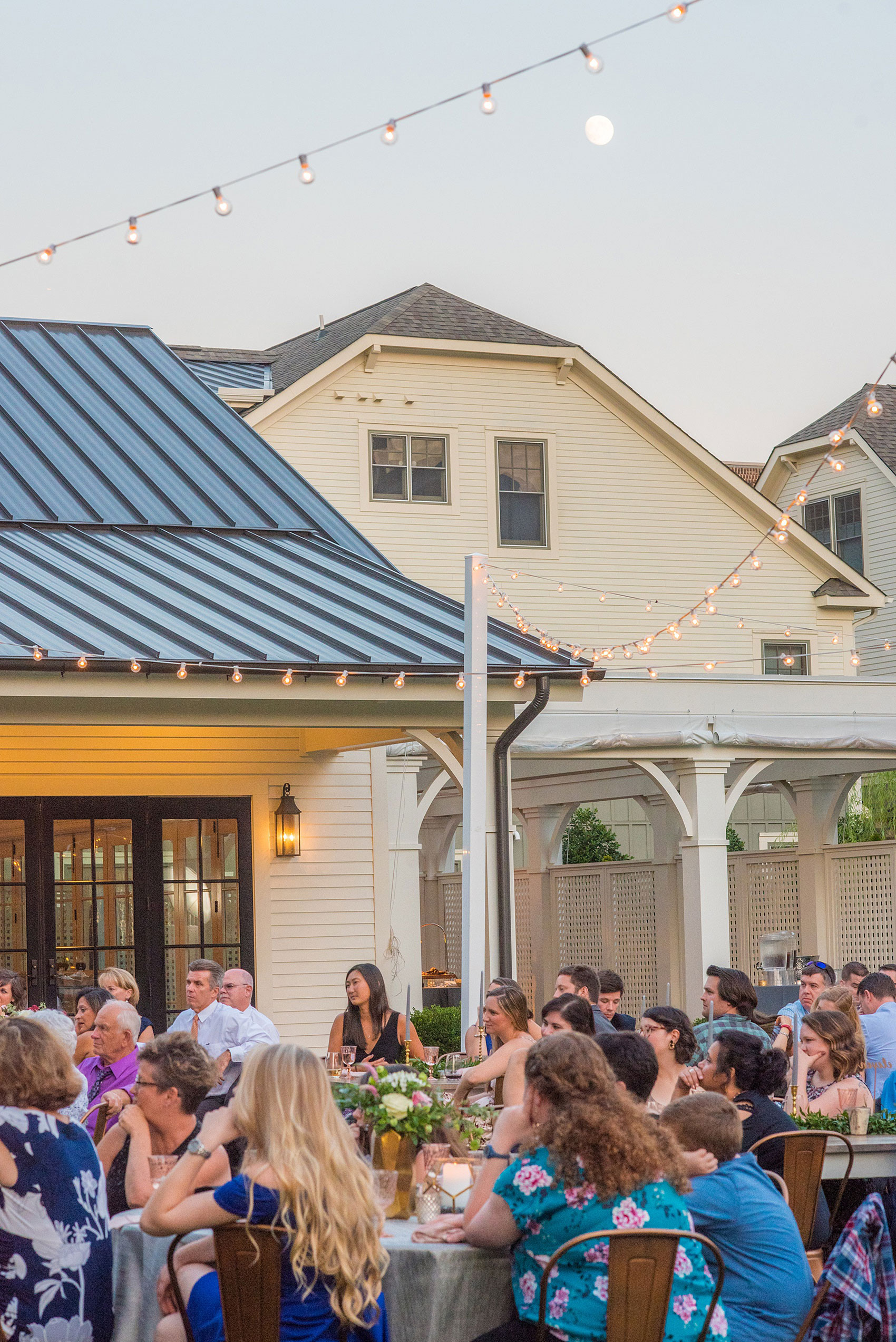 Mikkel Paige Photography pictures from a wedding at Merrimon-Wynne House in Raleigh, NC. Dusk photo of the dinner on the lawn and the moon.