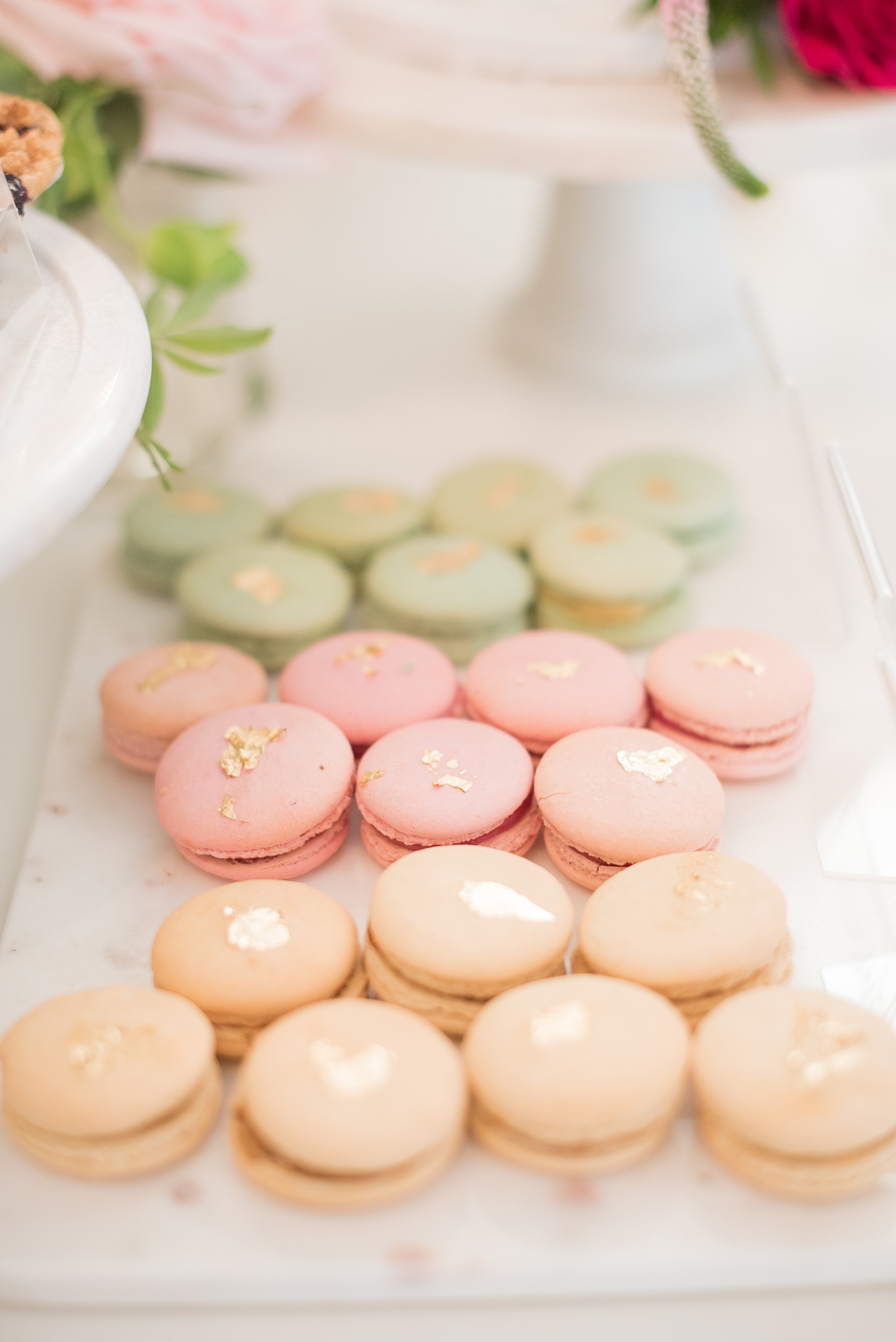 Mikkel Paige Photography pictures from a wedding at Merrimon-Wynne House in Raleigh, NC. Photo of macarons with gold leaf on the dessert table.