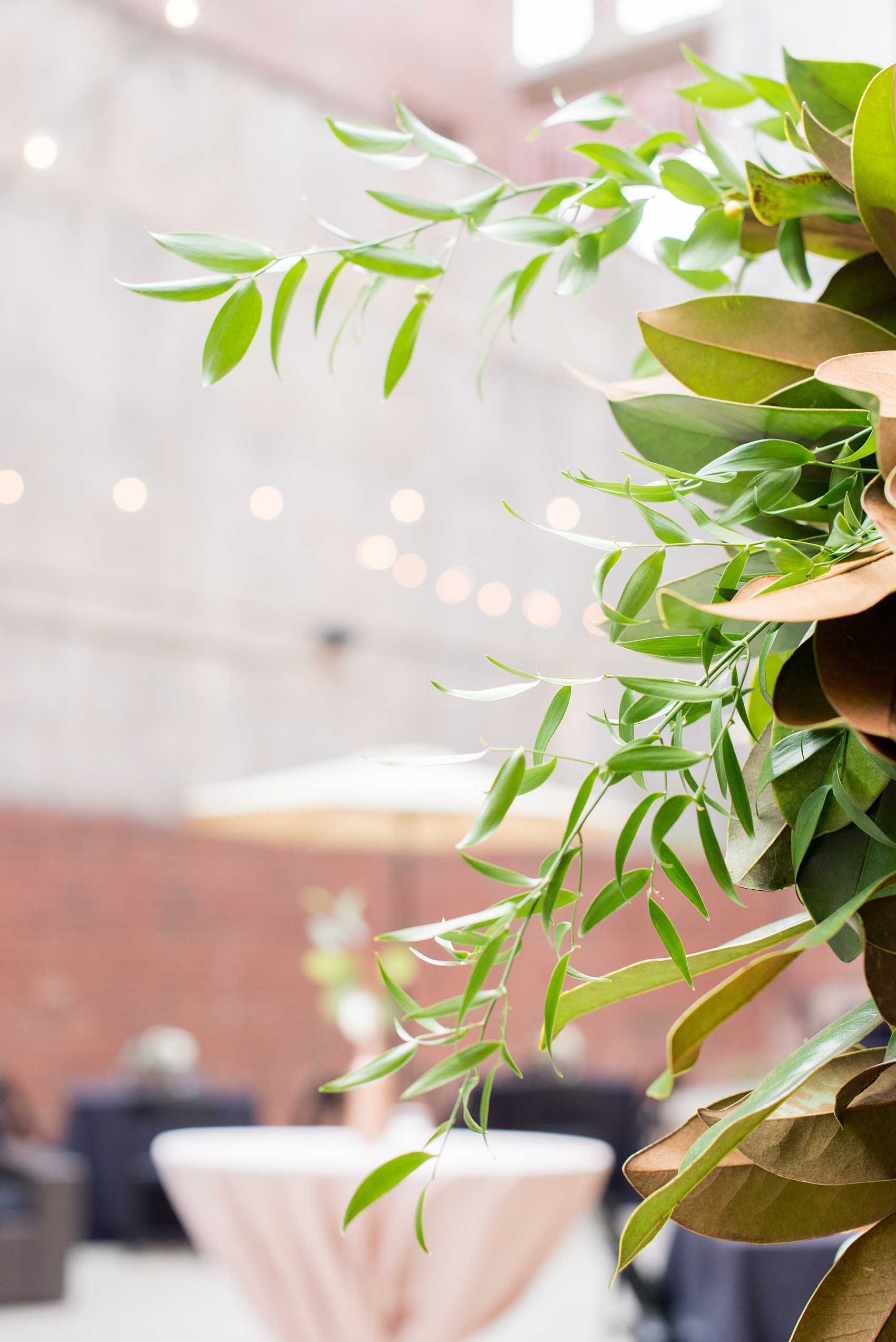 Mikkel Paige Photography photos from a downtown Raleigh wedding rehearsal dinner at Sitti restaurant. Picture of a garland wreath detail.