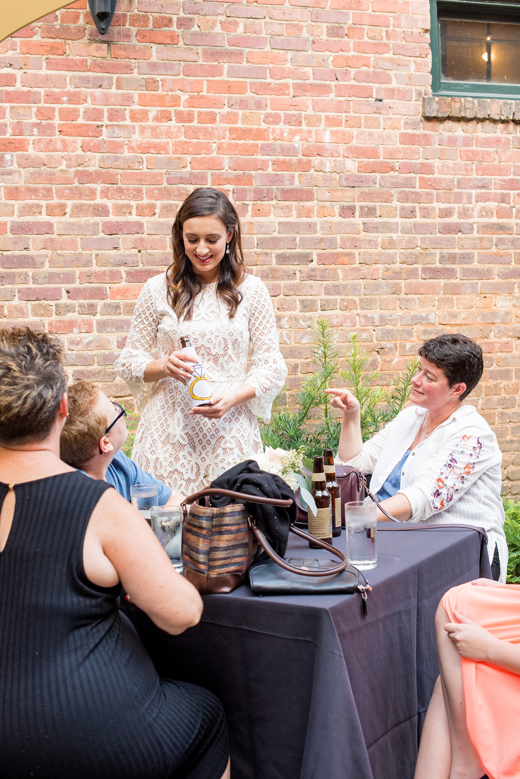 Mikkel Paige Photography photos from a downtown Raleigh wedding rehearsal dinner at Sitti restaurant. Picture of the pink hightop tables with bride mingleing with guests.