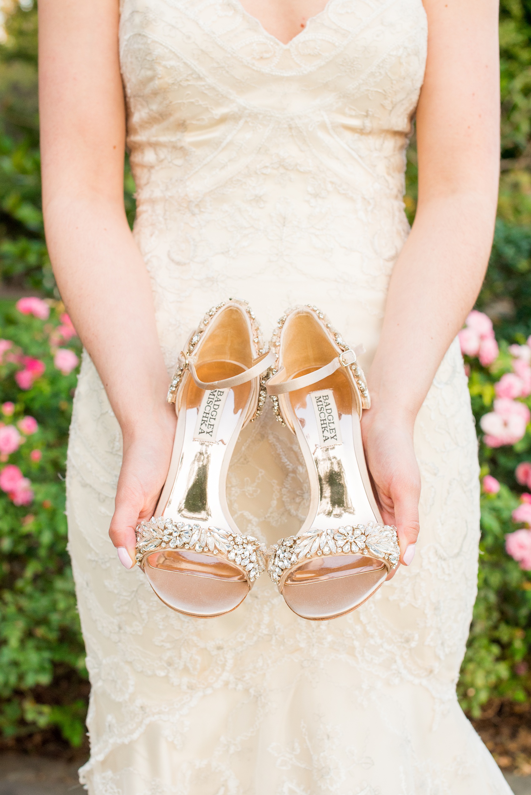 Mikkel Paige Photography photos from a bridal session at Raleigh's JC Raulston Arboretum on North Carolina's NC State campus. Picture of the bride holding her gold and rhinestone high heel Badgley Mischka wedding shoes.