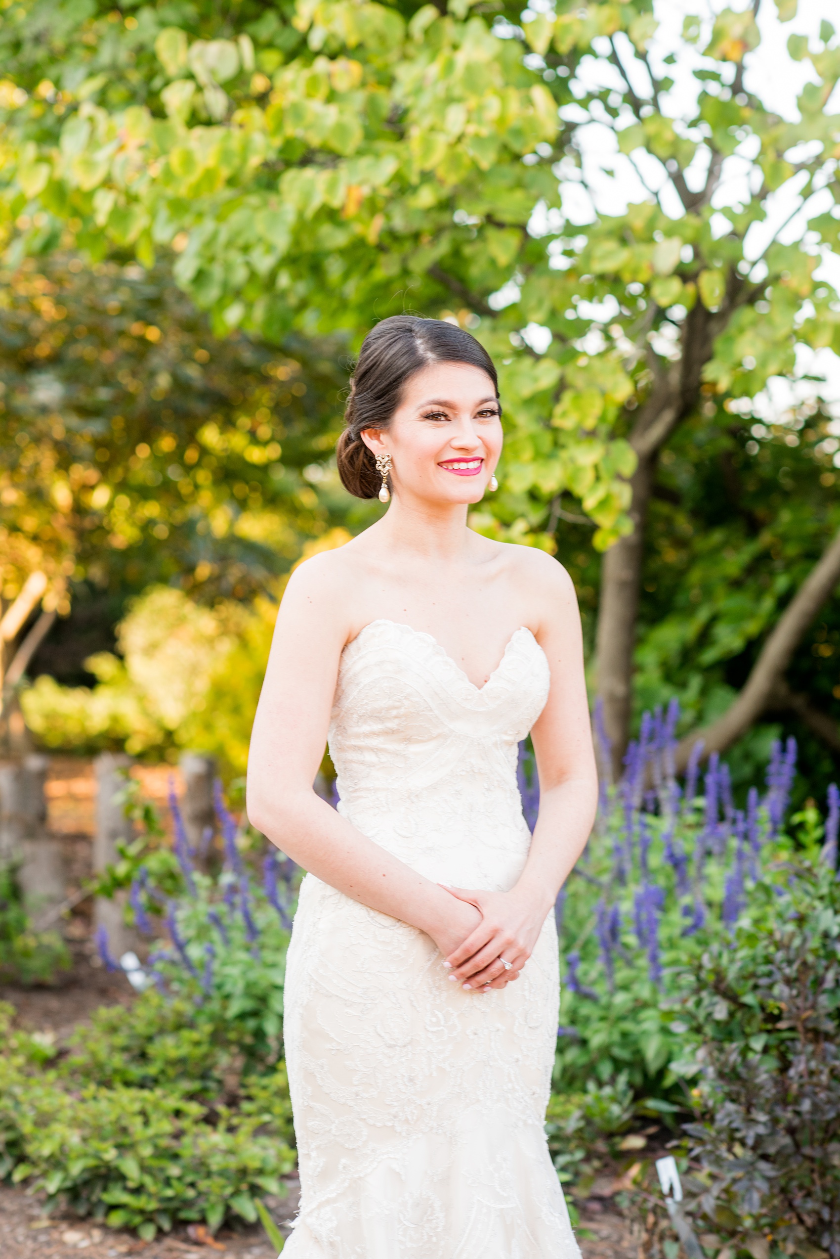 Mikkel Paige Photography photos from a bridal session at Raleigh's JC Raulston Arboretum on North Carolina's NC State campus. Picture of the bride with lilac flowers.