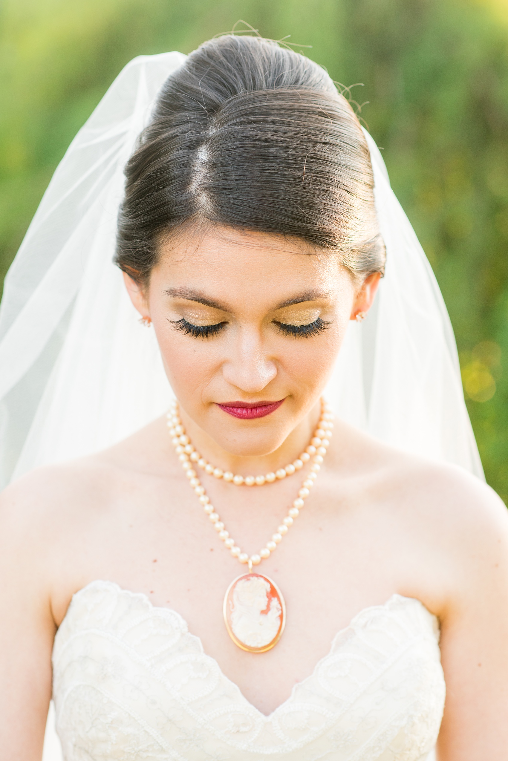 Mikkel Paige Photography photos from a bridal session at Raleigh's JC Raulston Arboretum on North Carolina's NC State campus. The bride wore an off-white vintage lace gown with a cameo and pearl necklace.