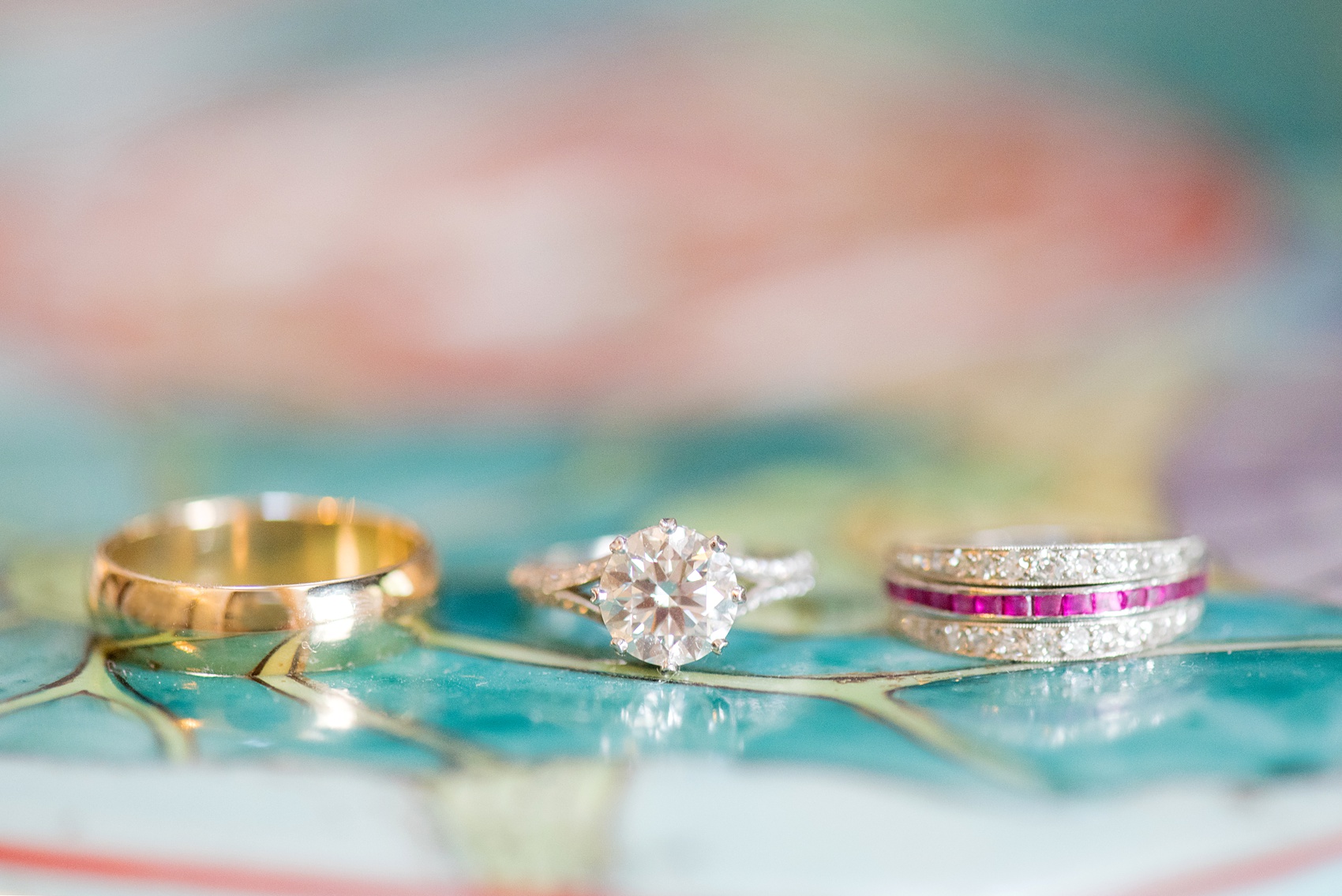 Mikkel Paige Photography photos from a wedding at Duke Chapel and Hope Valley Country Club in North Carolina. Detail photo of the bride and groom's gold, diamond and ruby rings.