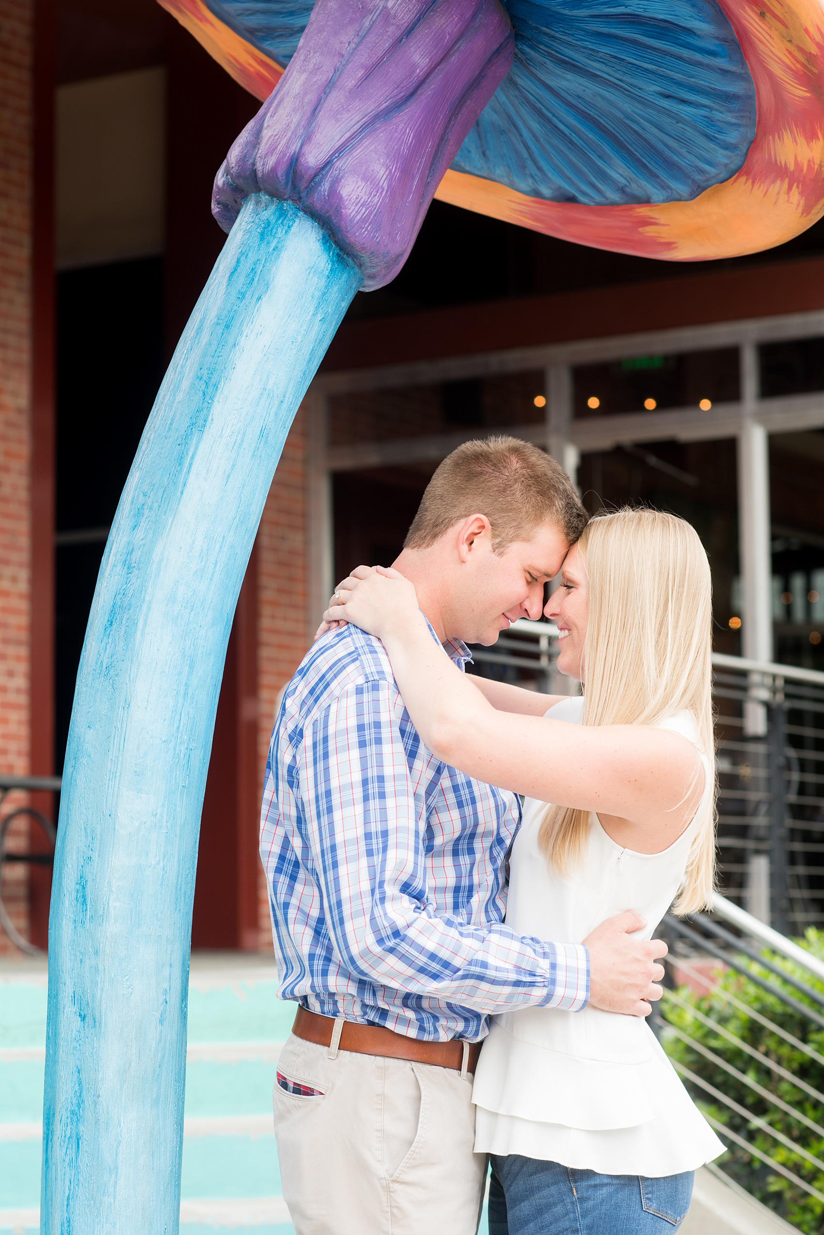 Mikkel Paige Photography photos from an engagement session at Durham's American Tobacco Campus in North Carolina. Colorful picture of the couple!