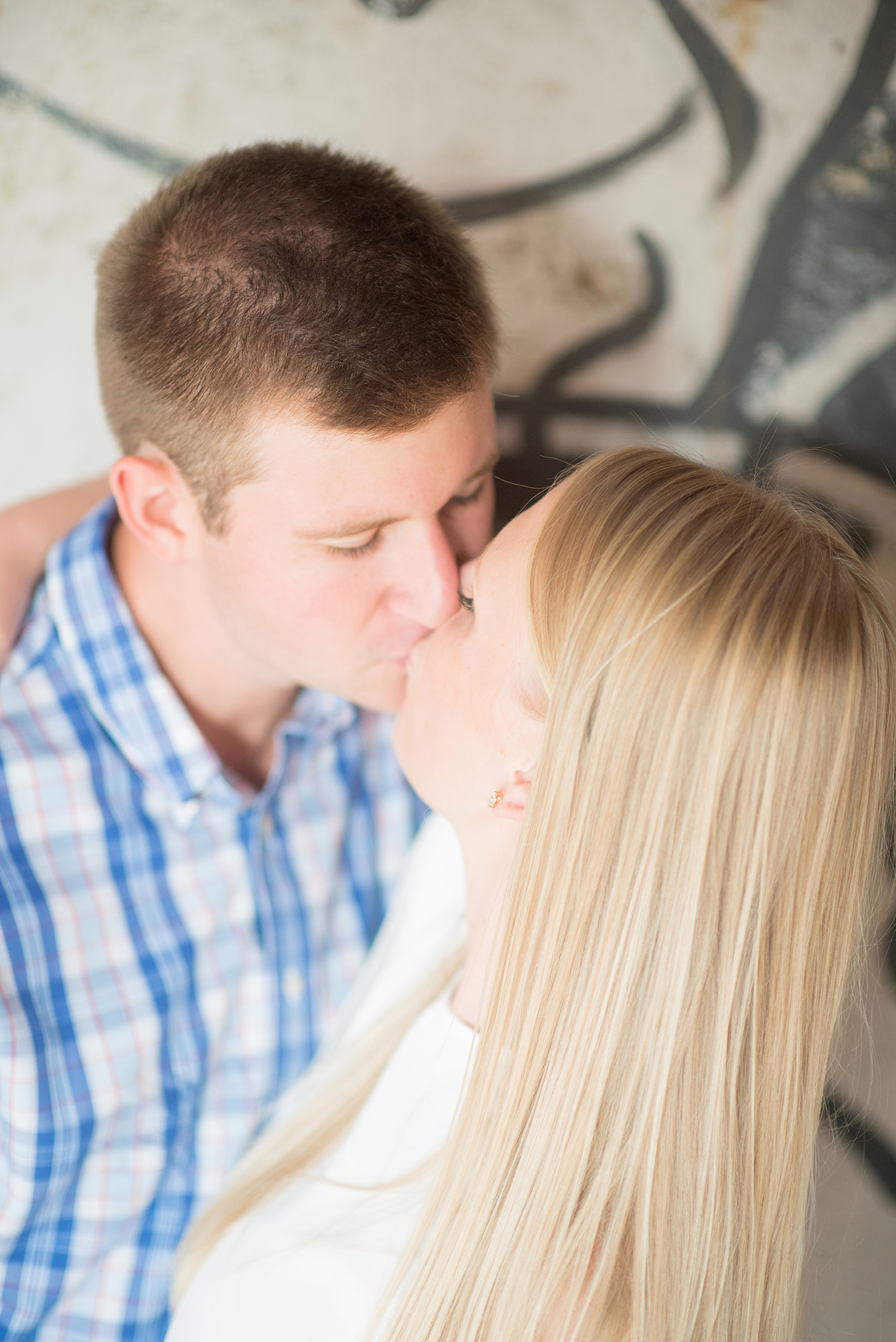 Mikkel Paige Photography photos from an engagement session at Durham's American Tobacco Campus in North Carolina. Sweet close-up photo of the couple.