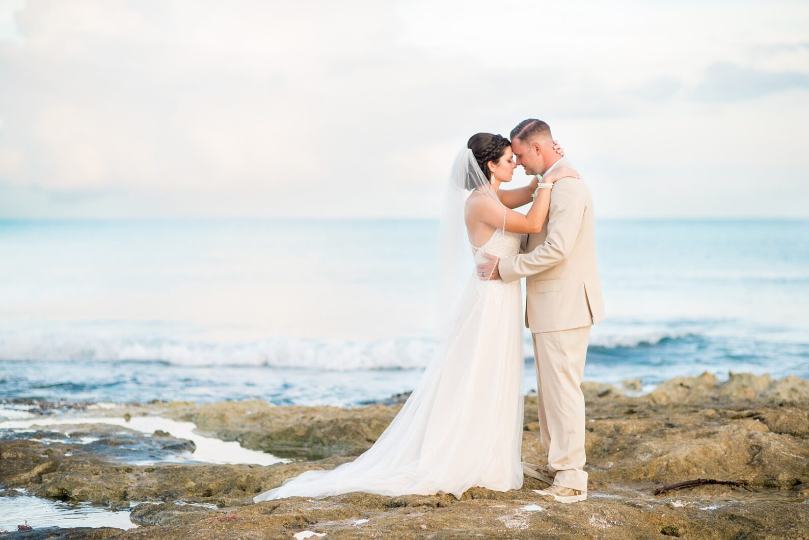 Mikkel Paige Photography photos from a wedding at Grand Paraiso, Mexico, Playa del Carmen Iberostar resort. Picture of the bride and groom on the ocean.