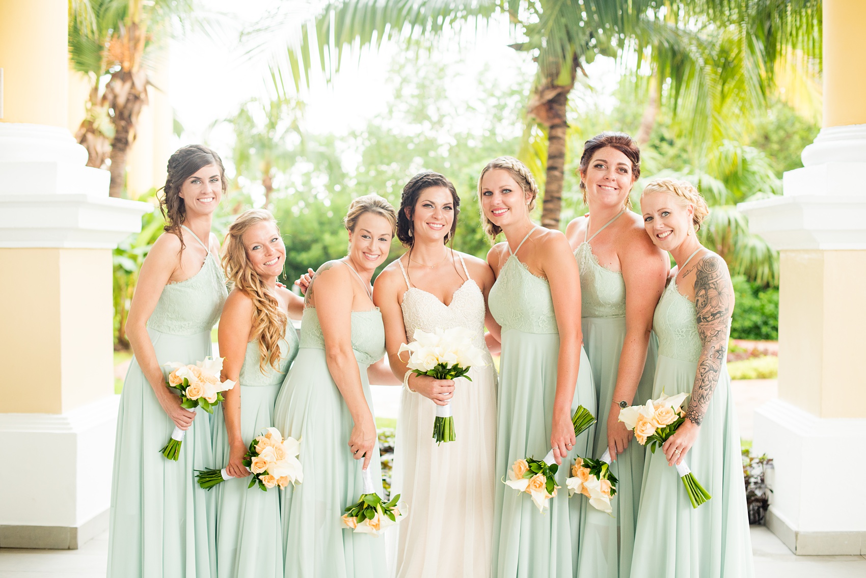 Mikkel Paige Photography photos from a wedding at Grand Paraiso, Mexico, Playa del Carmen Iberostar resort. Picture of the bride and her bridesmaids. The bridesmaids wore mint green gowns.