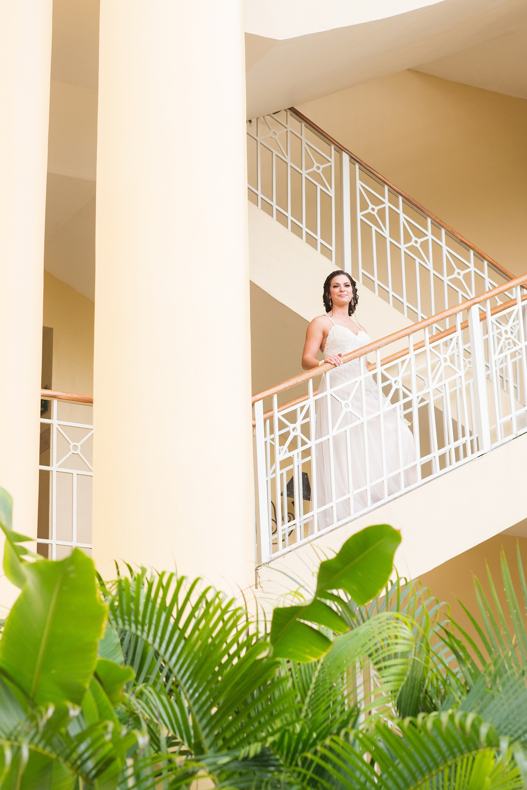 Mikkel Paige Photography photos from a wedding at Grand Paraiso, Mexico, Playa del Carmen Iberostar resort. Picture of the bride in on a staircase at the resort.