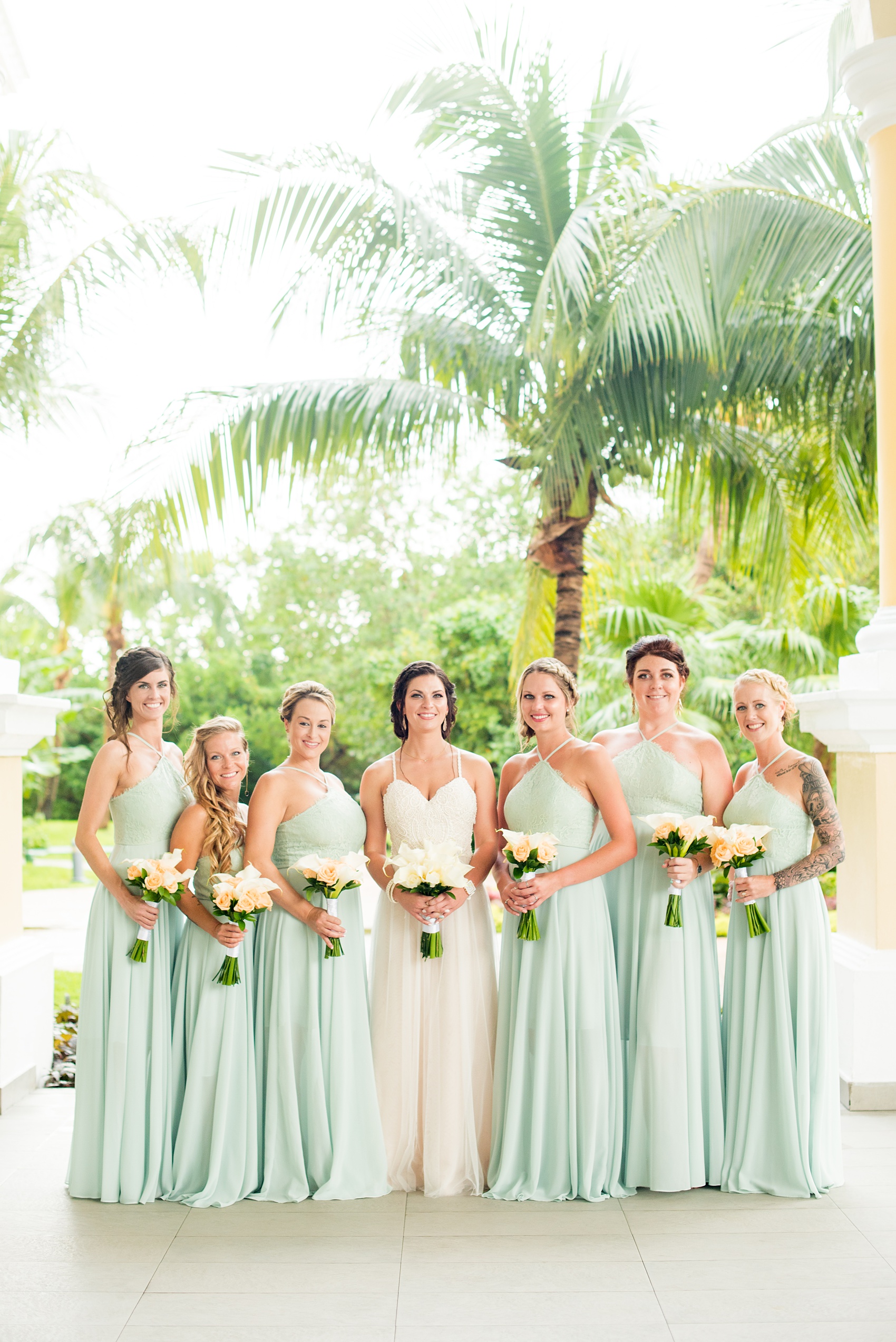 Mikkel Paige Photography photos from a wedding at Grand Paraiso, Mexico, Playa del Carmen Iberostar resort. Picture of the bride and her bridesmaids. The bridesmaids wore mint green gowns.