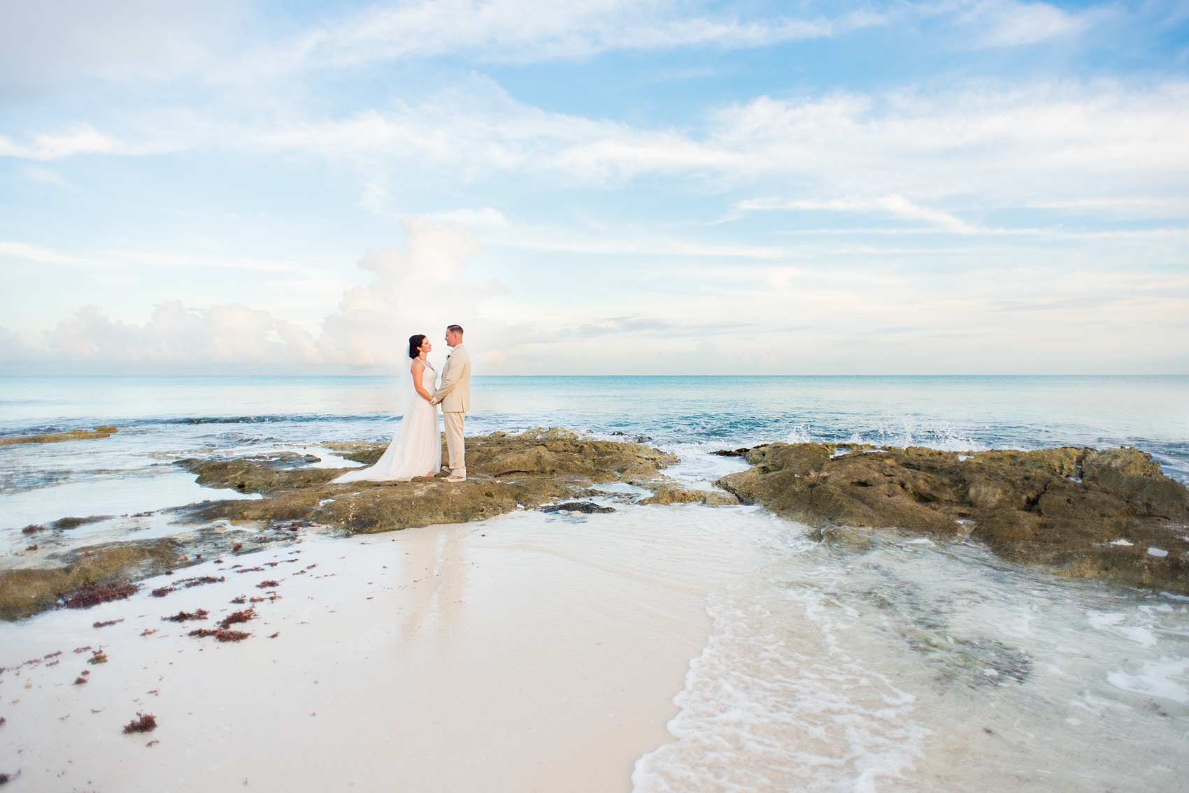 Mikkel Paige Photography photos from a wedding at Grand Paraiso, Mexico, Playa del Carmen Iberostar resort. Picture of the bride and groom on the ocean.