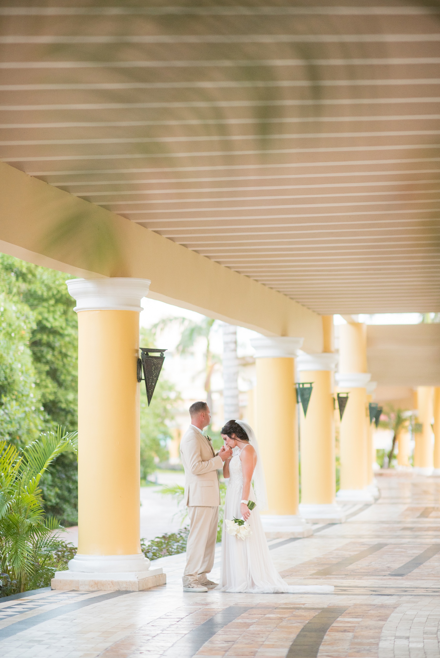 Mikkel Paige Photography photos from a wedding at Grand Paraiso, Mexico, Playa del Carmen Iberostar resort. Candid picture of the bride and groom at the resort.