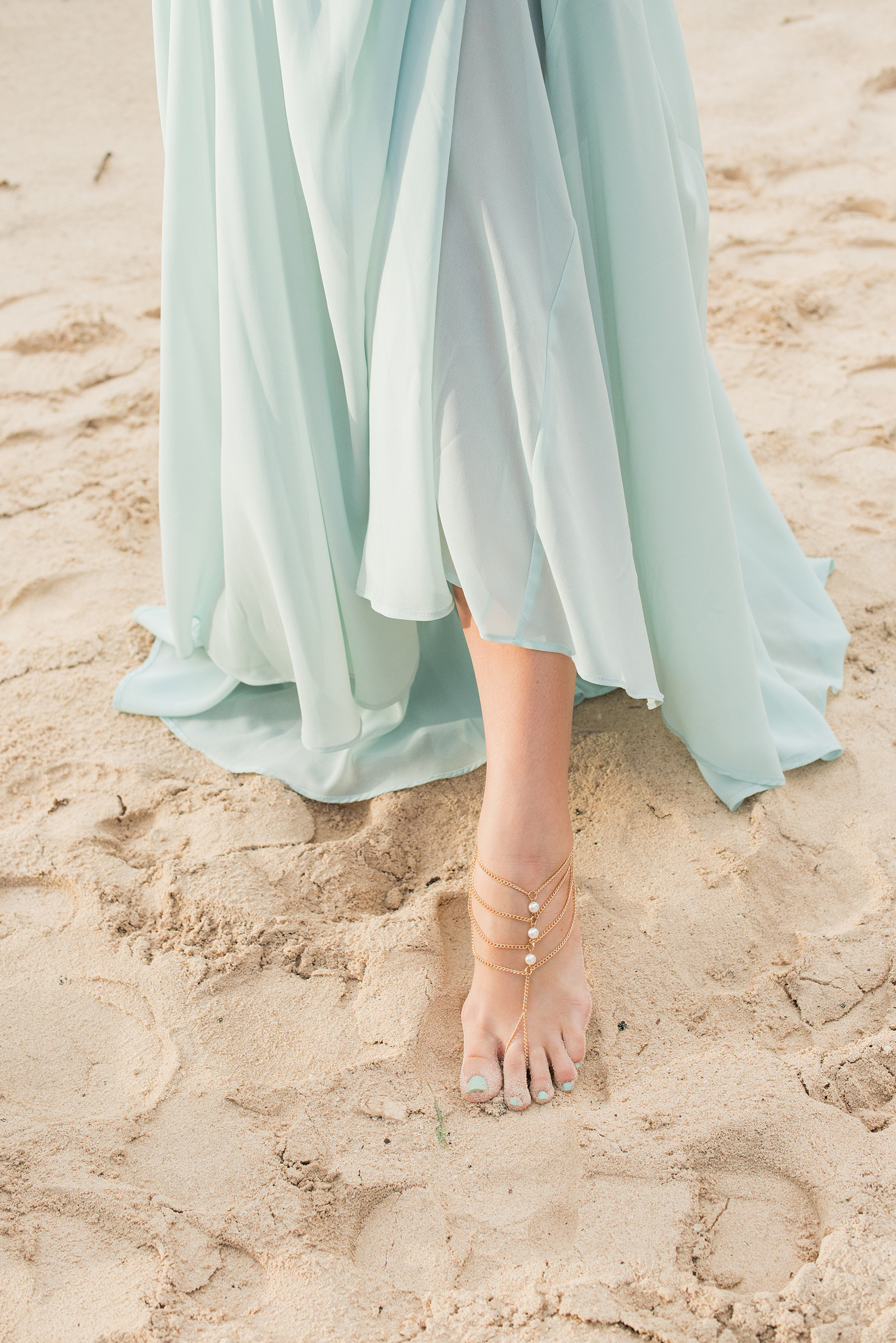 Mikkel Paige Photography photos from a wedding at Grand Paraiso, Mexico, Playa del Carmen Iberostar resort. Picture of the bridesmaid's foot jewelry on the beach.