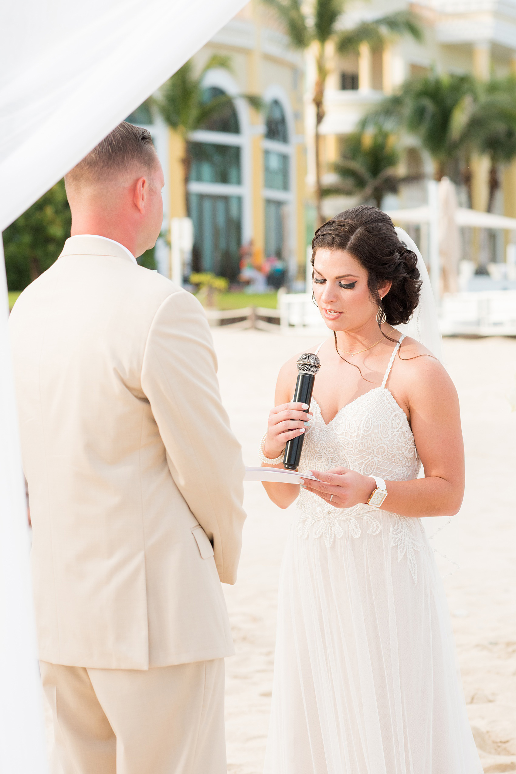 Mikkel Paige Photography photos from a wedding at Grand Paraiso, Mexico, Playa del Carmen Iberostar resort. Picture of the bride reciting her vows at their beach ceremony.