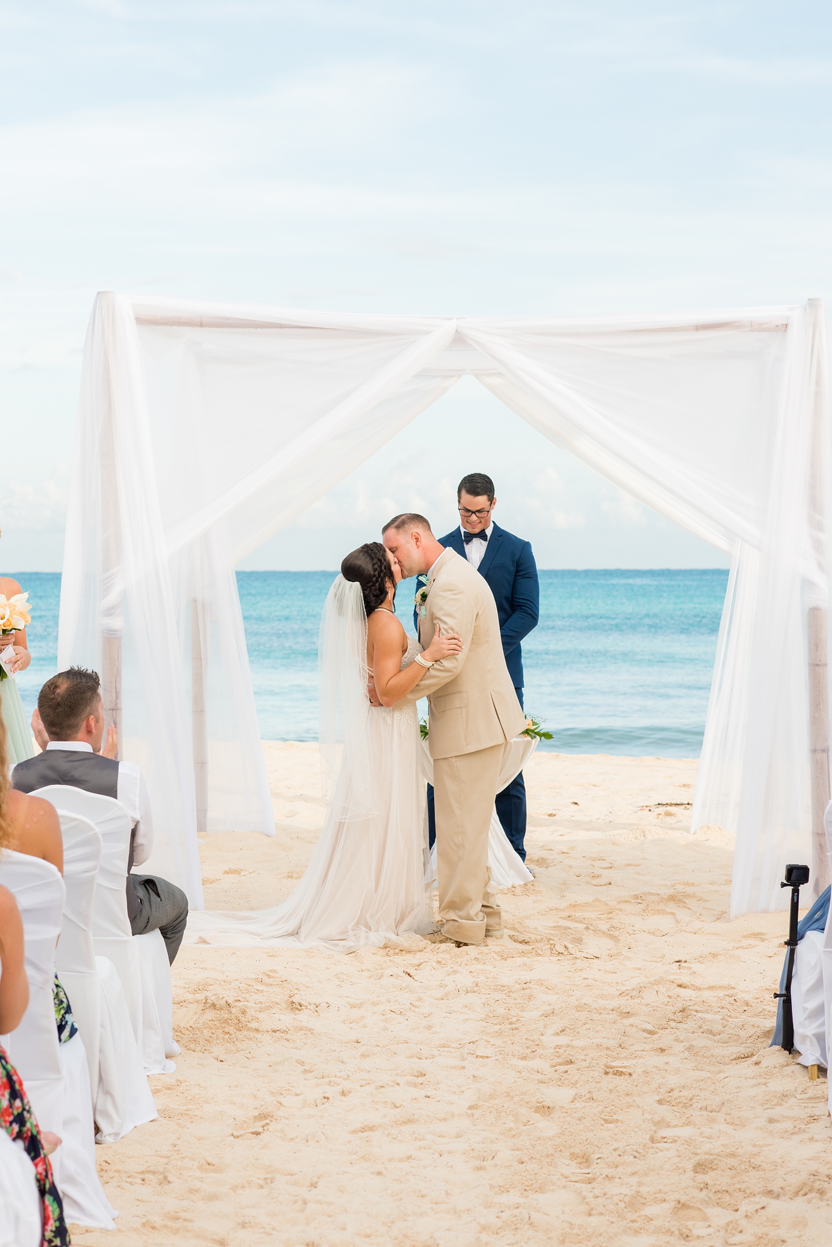 Mikkel Paige Photography photos from a wedding at Grand Paraiso, Mexico, Playa del Carmen Iberostar resort. Picture of the bride and groom's first kiss at their beach ceremony.