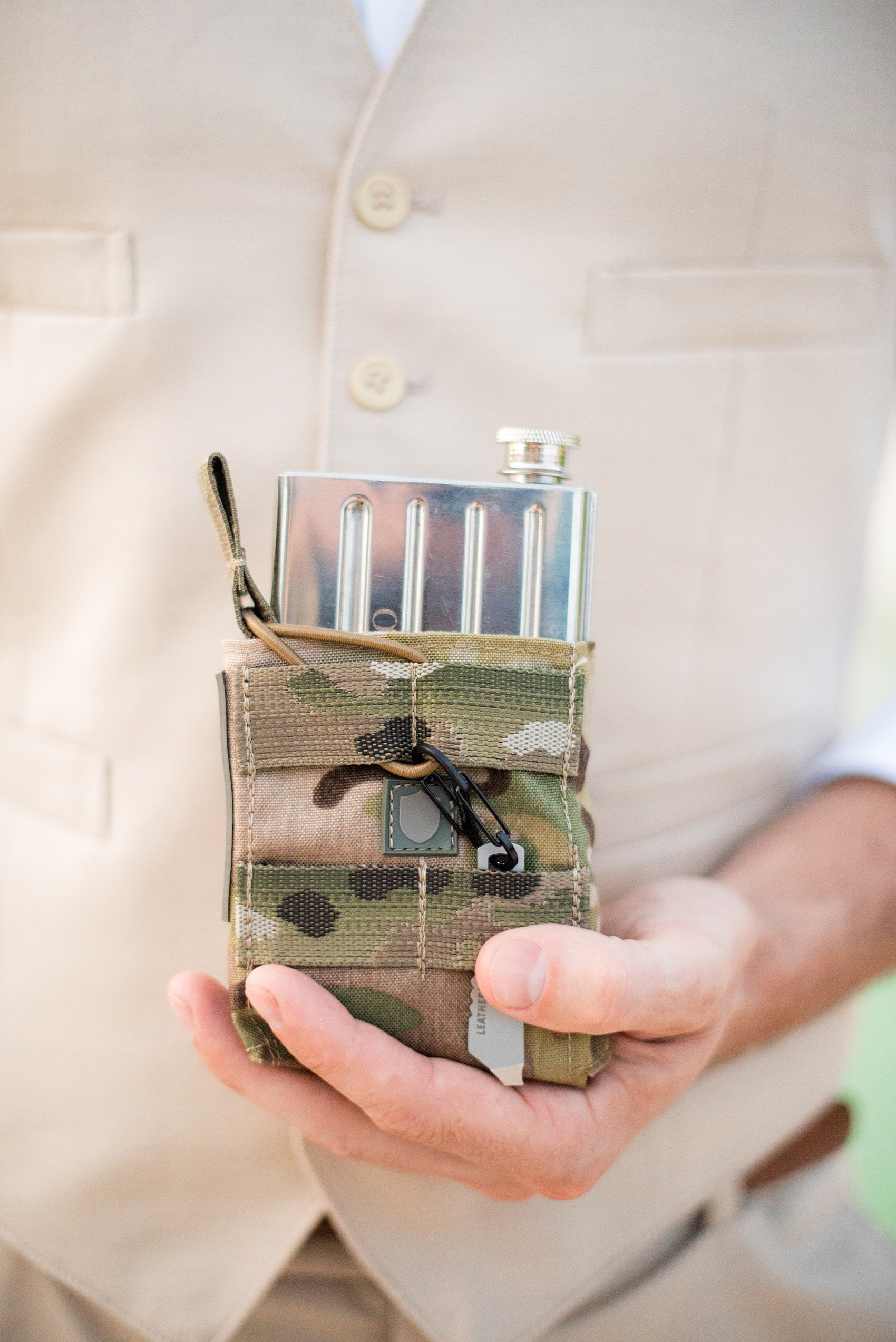 Mikkel Paige Photography photos from a wedding at Grand Paraiso, Mexico, Playa del Carmen Iberostar resort. Picture of a groomsman with his army, military flasks from the groom.