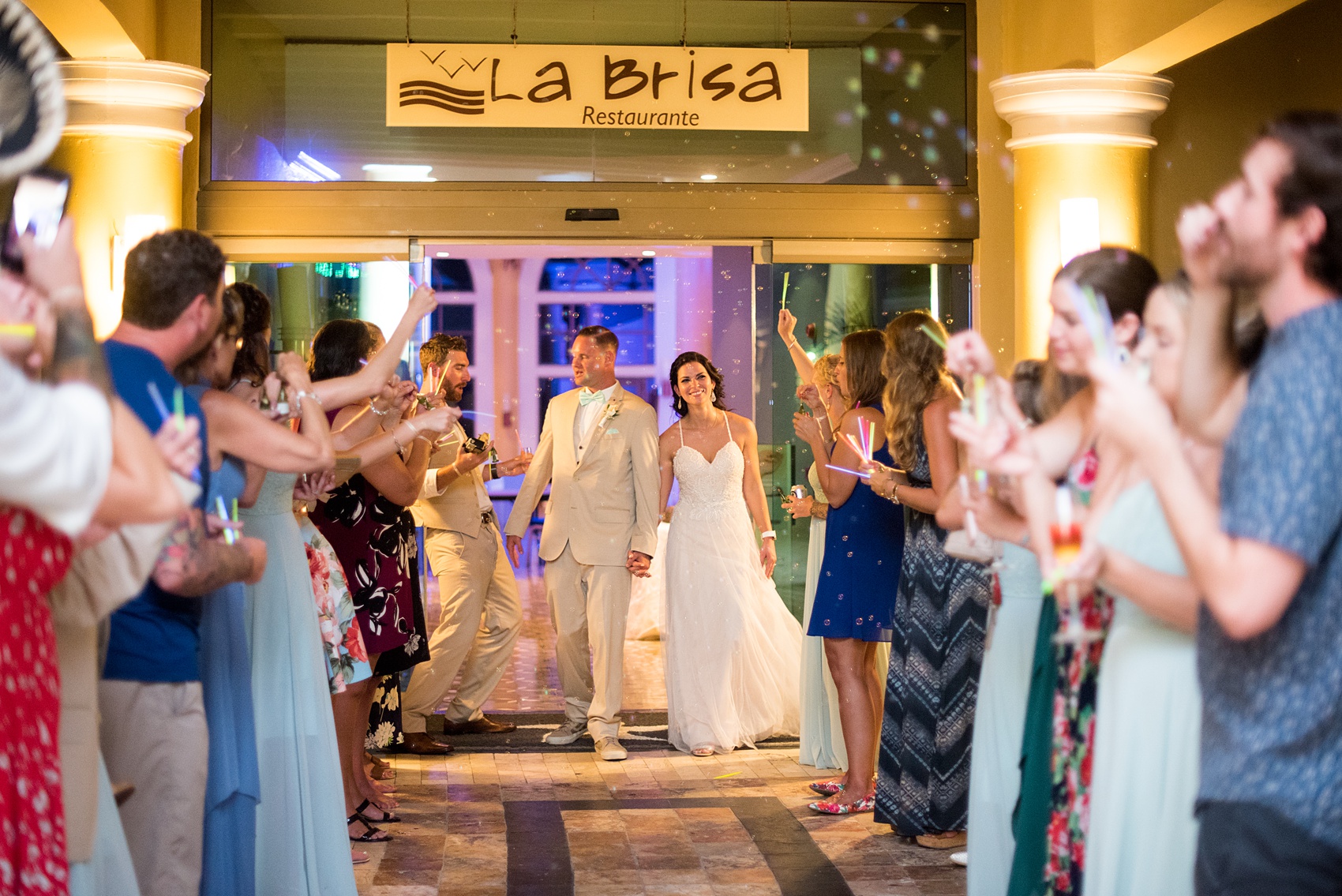 Mikkel Paige Photography photos from a wedding at Grand Paraiso, Mexico, Playa del Carmen Iberostar resort. Picture of bride and groom's bubble and glow stick exit.