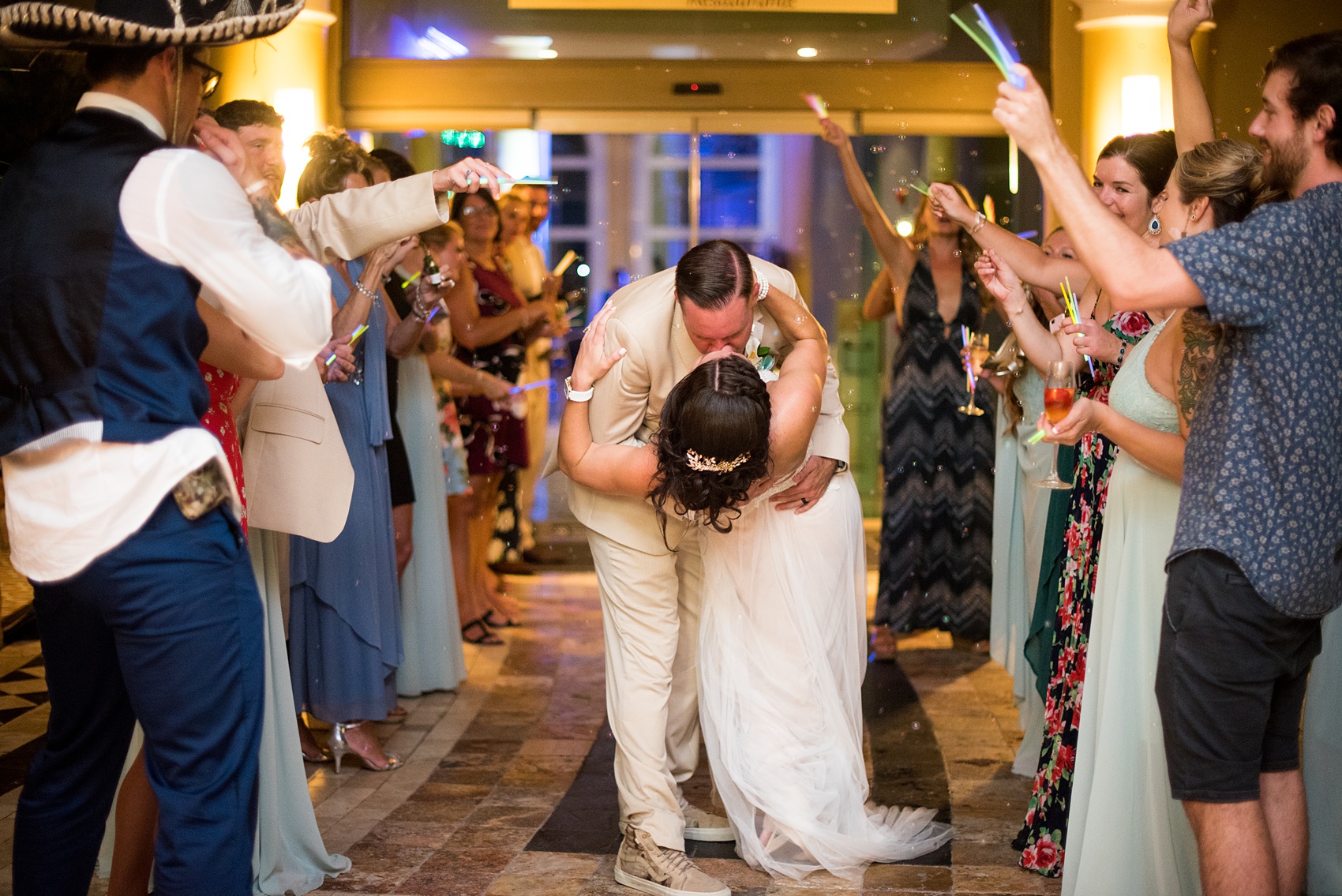 Mikkel Paige Photography photos from a wedding at Grand Paraiso, Mexico, Playa del Carmen Iberostar resort. Picture of bride and groom's bubble and glow stick exit.