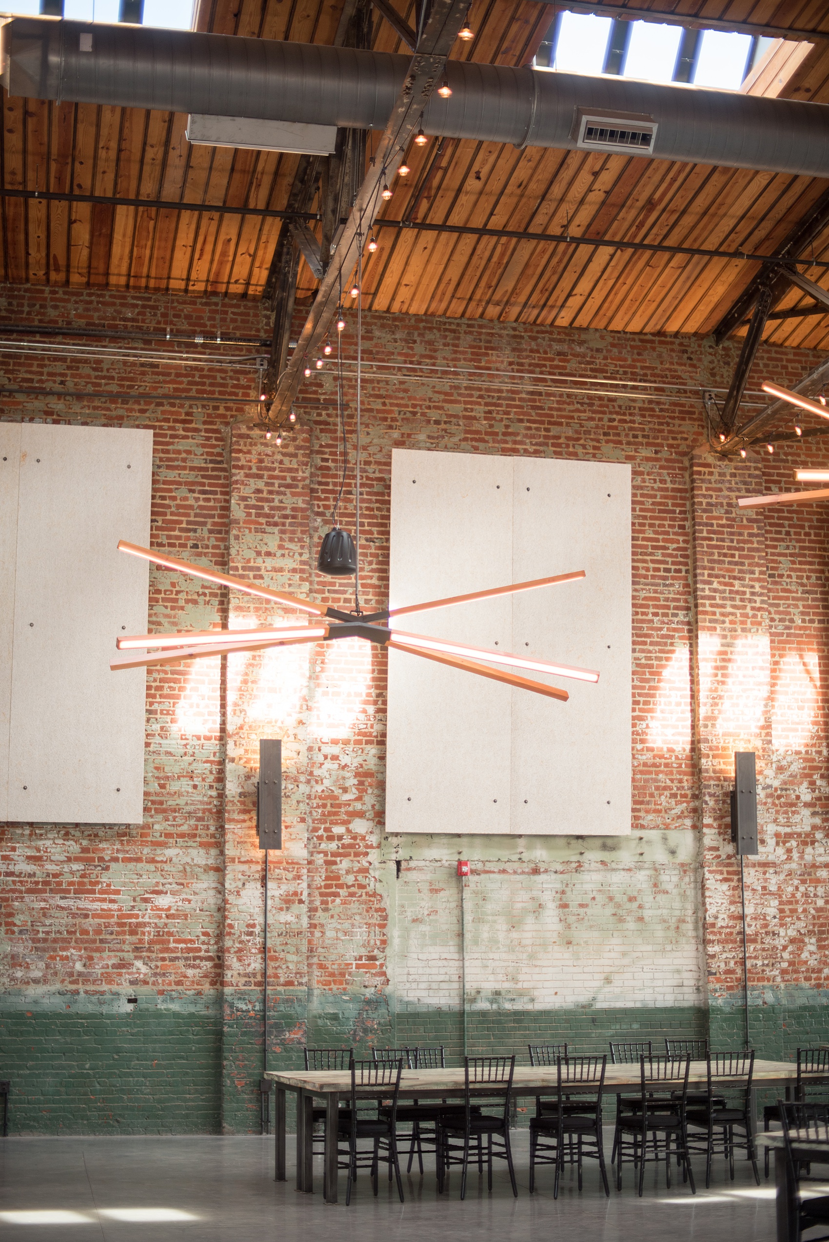 Mikkel Paige Photography pictures of Cadillac Service Garage venue in Greensboro, North Carolina. Photo of the interior reception room with 30 foot ceilings.