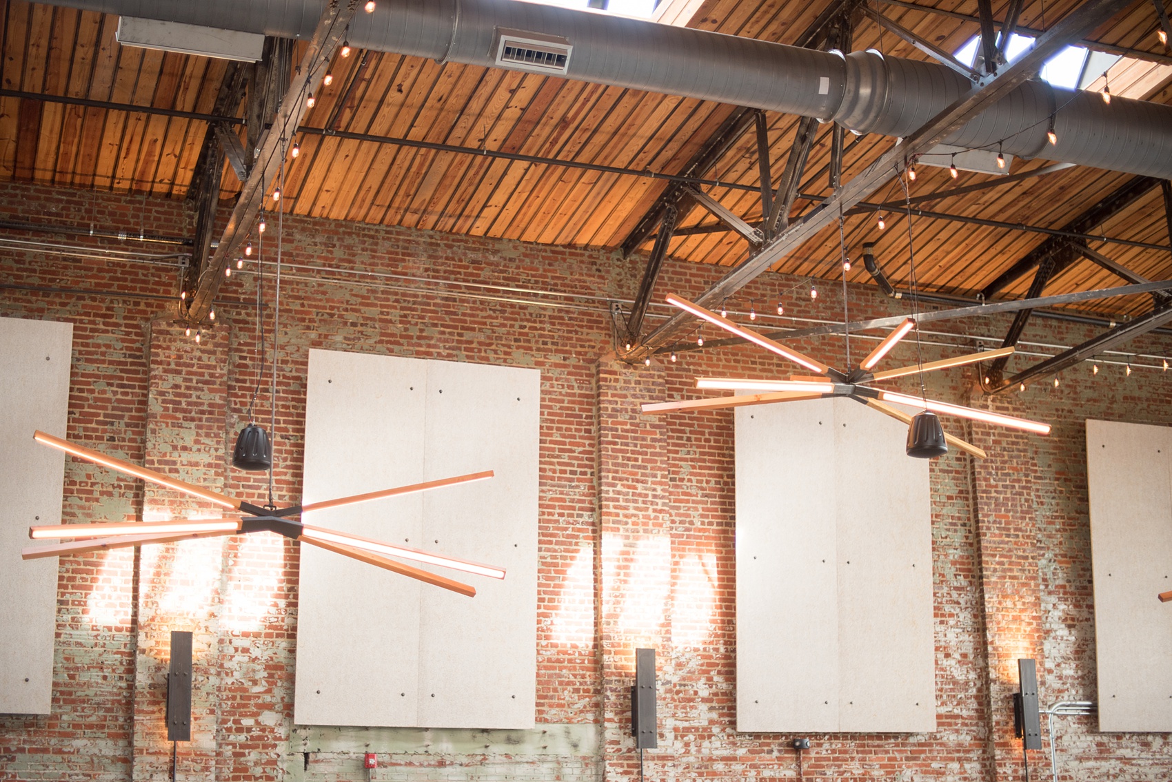 Mikkel Paige Photography pictures of Cadillac Service Garage venue in Greensboro, North Carolina. Photo of the interior reception room with 30 foot ceilings.