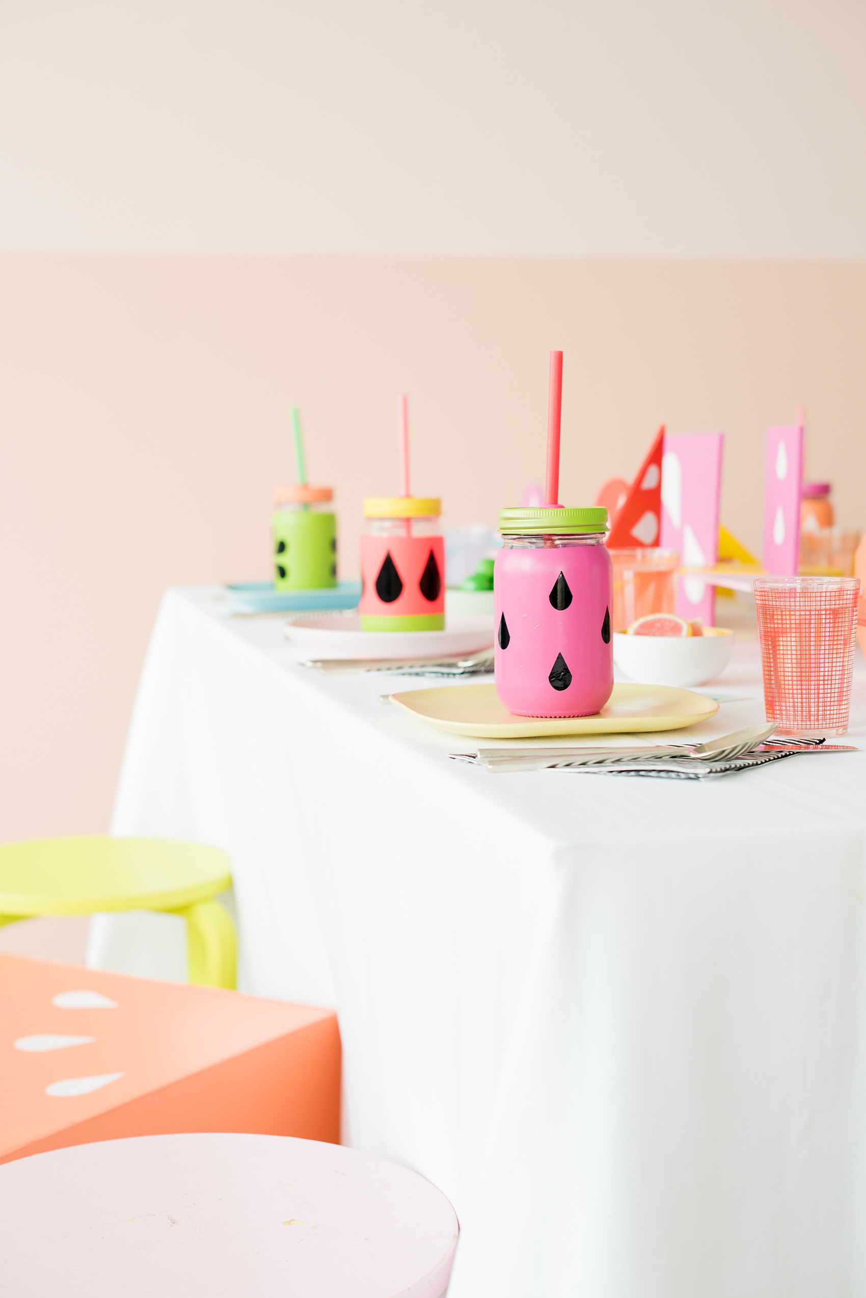 Mikkel Paige Photography photos of a Tutti Frutti theme birthday party. Featured on Martha Stewart. Picture of the kids party table by Michelle Bablo with colorful interlocking shapes and custom drink holders. Coordination by Color Pop Events.