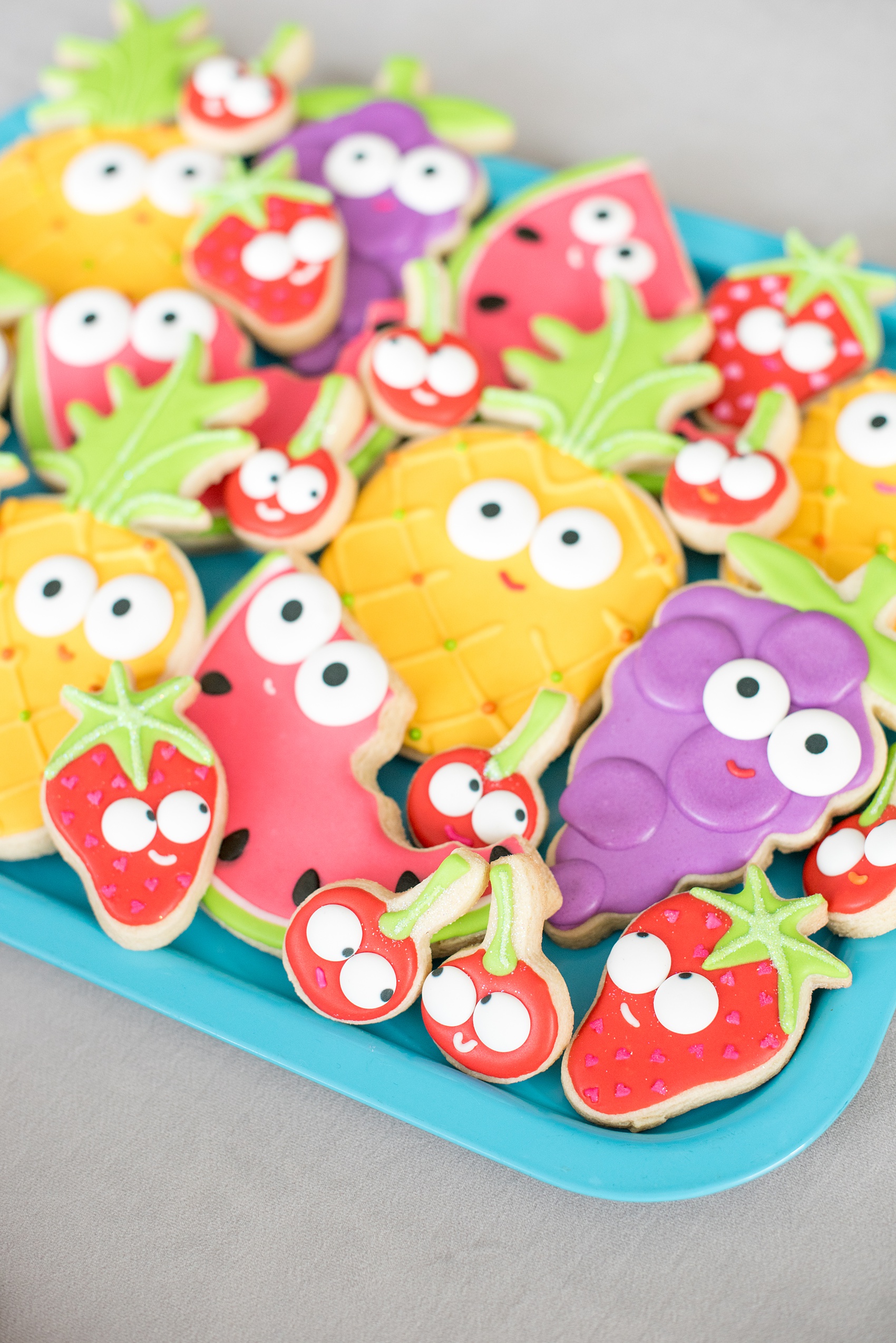 Mikkel Paige Photography photos of a Tutti Frutti theme birthday party. Featured on Martha Stewart. Picture of fruit sugar cookies with googly eyes by Sweet Dani B. Coordination by Color Pop Events.