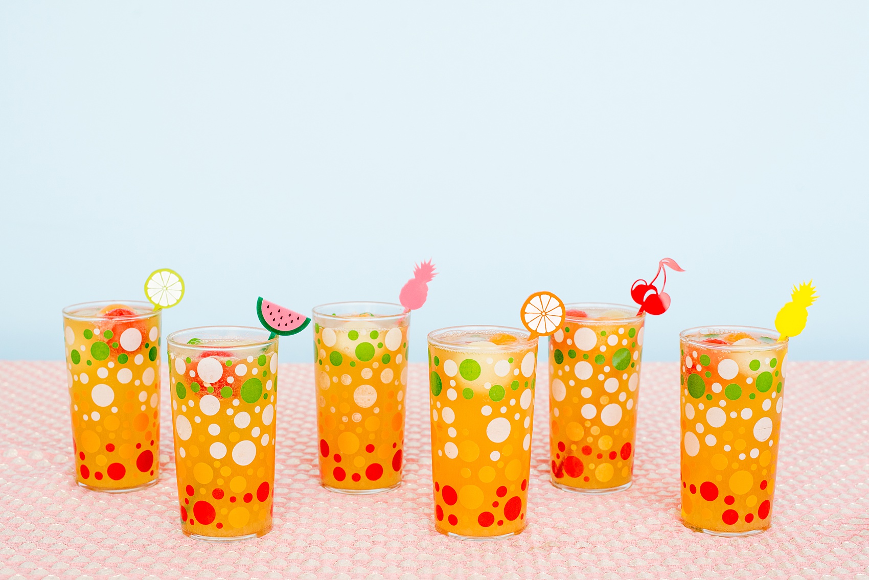 Mikkel Paige Photography photos of a Tutti Frutti theme birthday party. Featured on Martha Stewart. Picture of fruit cocktails and acrylic drink stirrers by California Lustre. Coordination by Color Pop Events.