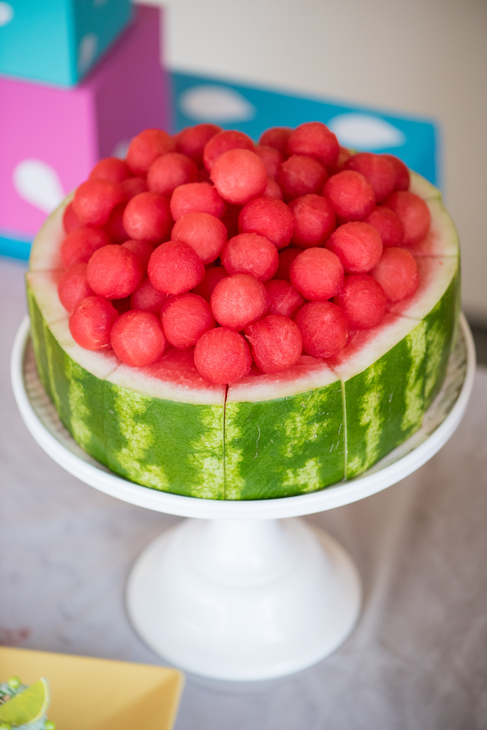 Mikkel Paige Photography photos of a Tutti Frutti theme birthday party. Featured on Martha Stewart. Picture of a balled watermelon "cake" by Sugar Monster. Coordination by Color Pop Events.