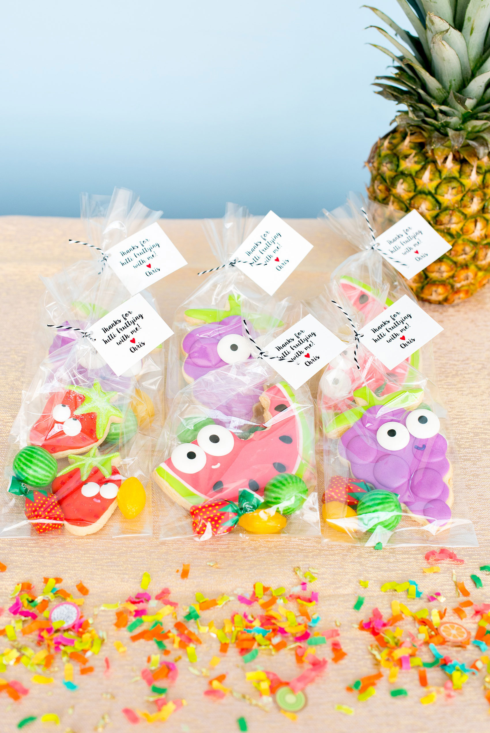 Mikkel Paige Photography photos of a Tutti Frutti theme birthday party. Featured on Martha Stewart. Picture of fruit sugar cookies with googly eyes by Sweet Dani B. Coordination by Color Pop Events, confetti from The Confetti Bar.