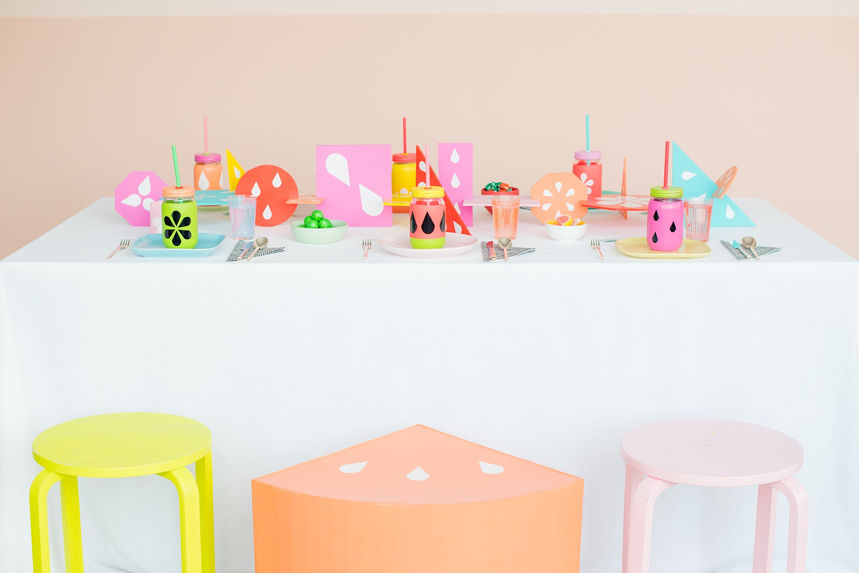 Mikkel Paige Photography photos of a Tutti Frutti theme birthday party. Featured on Martha Stewart. Picture of the kids party table by Michelle Bablo with colorful interlocking shapes and custom drink holders. Coordination by Color Pop Events.