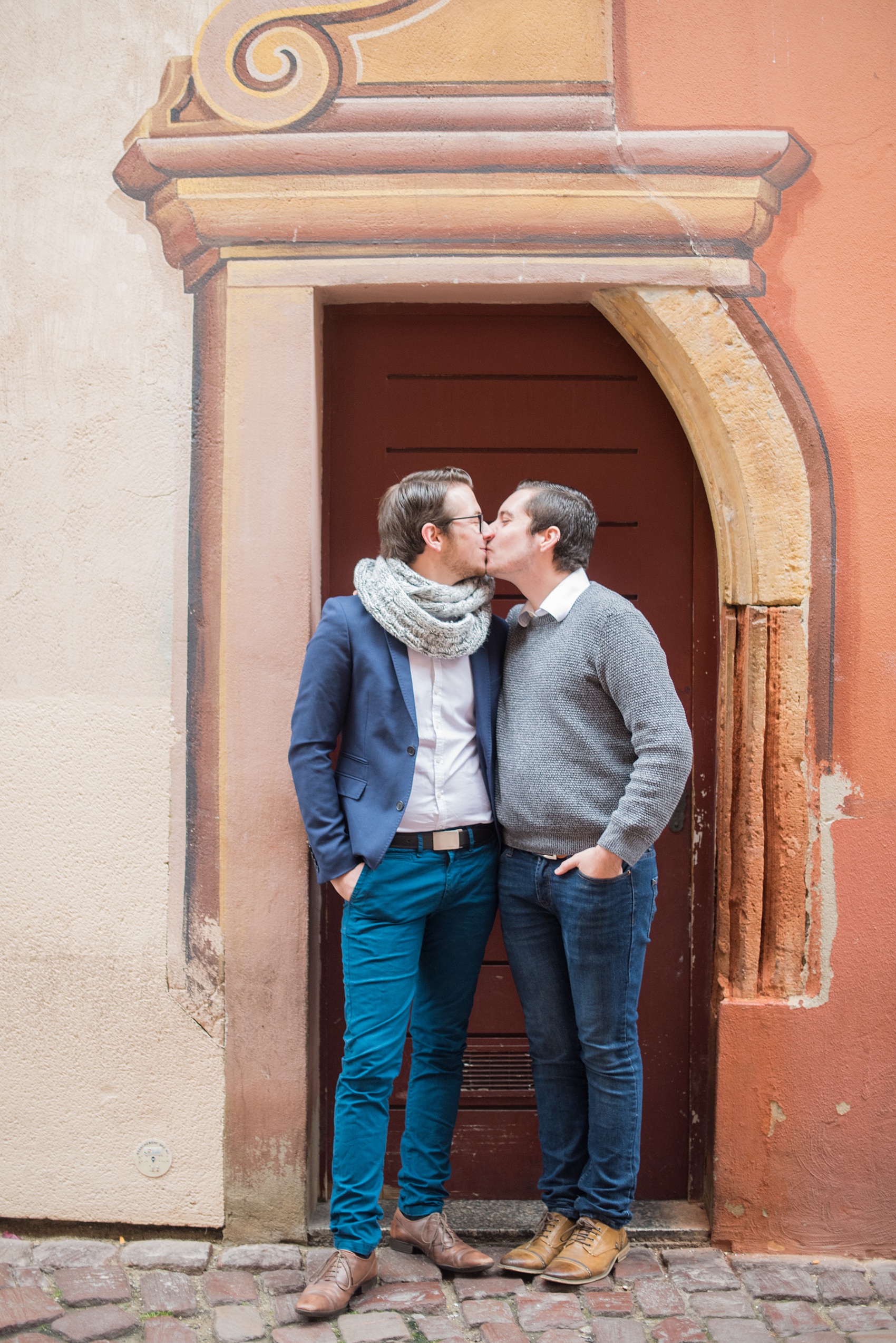 Mikkel Paige Photography pictures of an engagement session in Colmar, France in the Alsace region. Photo of the same sex gay couple in a Trompe l'Oeil door.