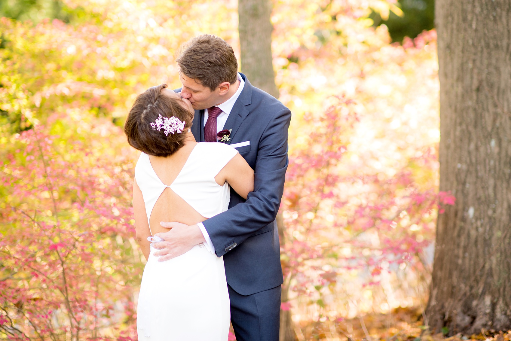 Mikkel Paige Photography photos from a wedding at Crabtree's Kittle House. Picture of the bride and groom kissing with the fall foliage.