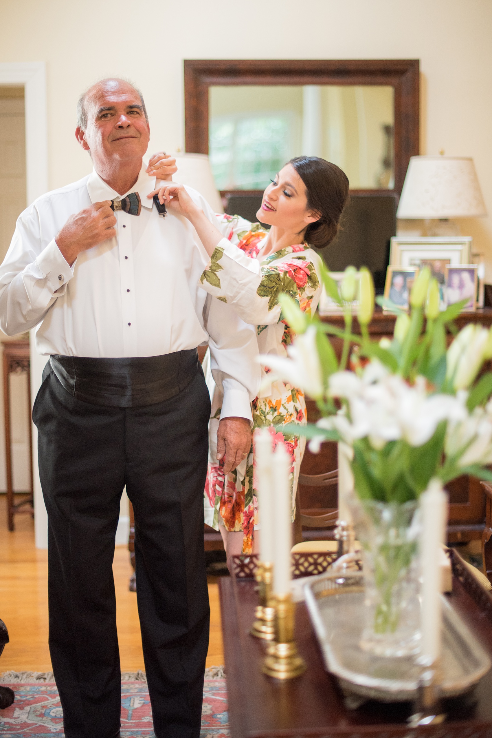 Mikkel Paige Photography photo of a wedding in Chapel Hill at Duke Chapel. Picture of the bride helping her father get ready.