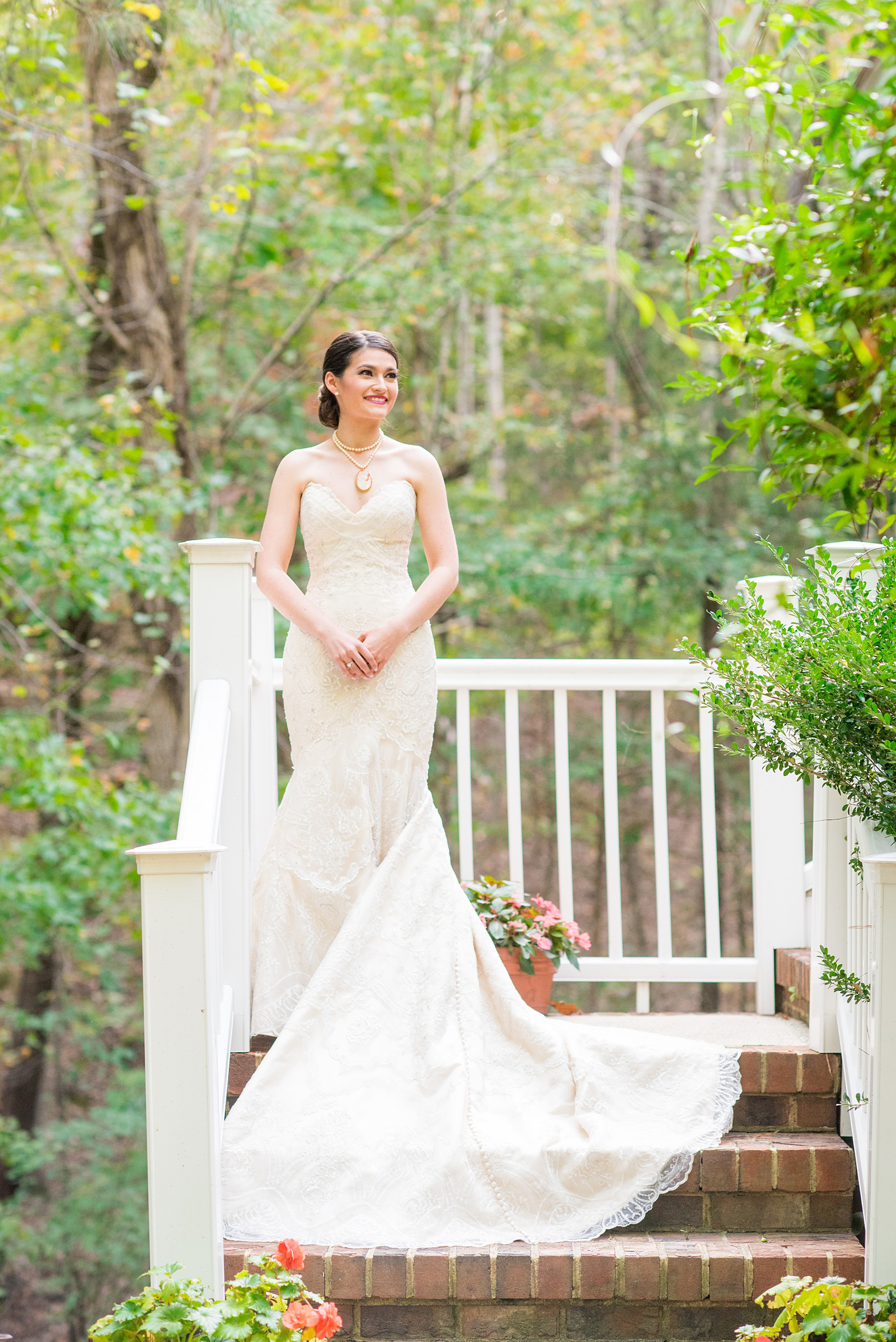 Mikkel Paige Photography photo of a wedding in Chapel Hill at Duke Chapel. Picture of the bride in her strapless, off white wedding gown at her childhood home. 