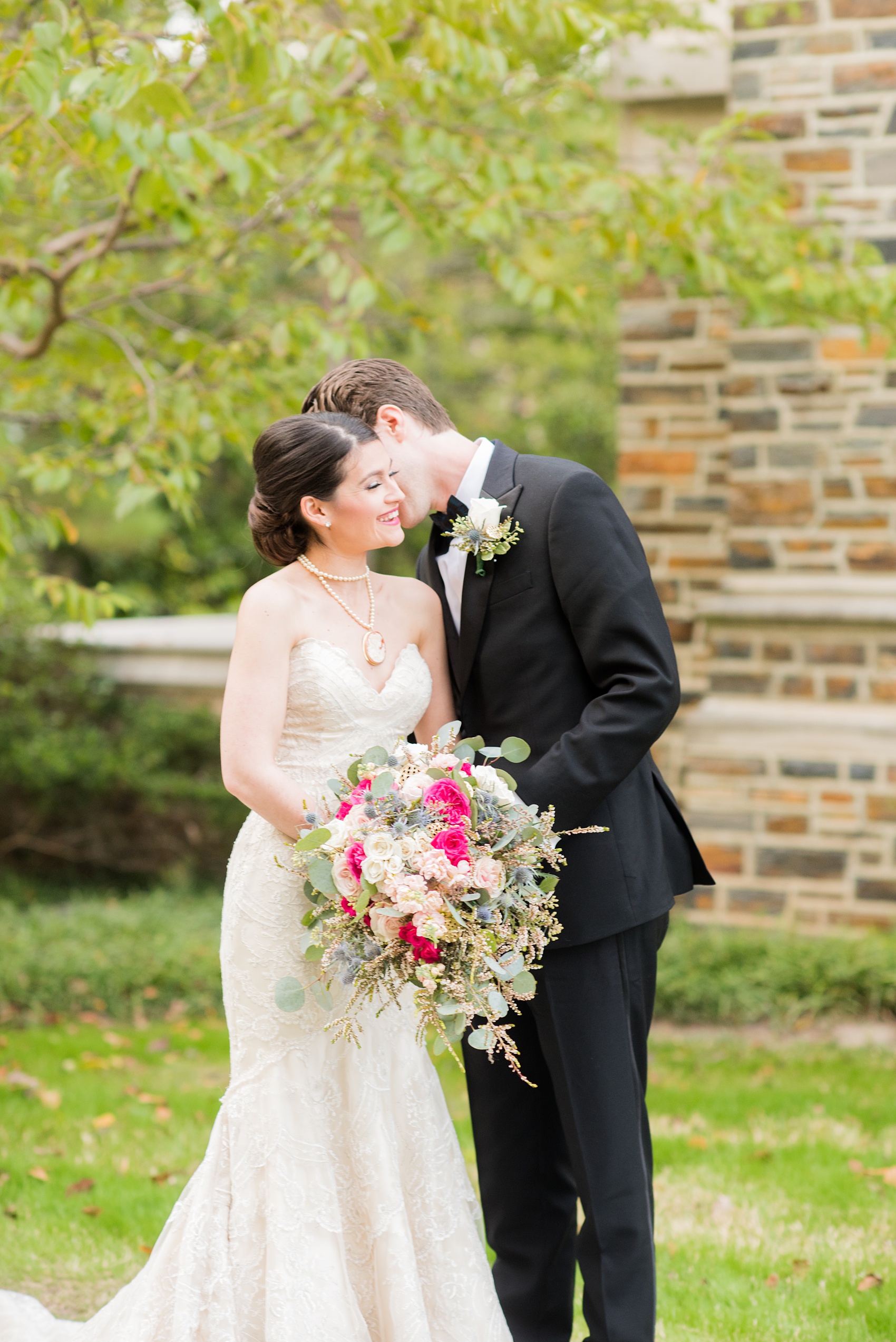 Mikkel Paige Photography photo of a wedding in Chapel Hill at Duke Chapel. Bride and groom with the gothic architecture. A picture the couple in a black tuxedo strapless sweetheart off-white gown.