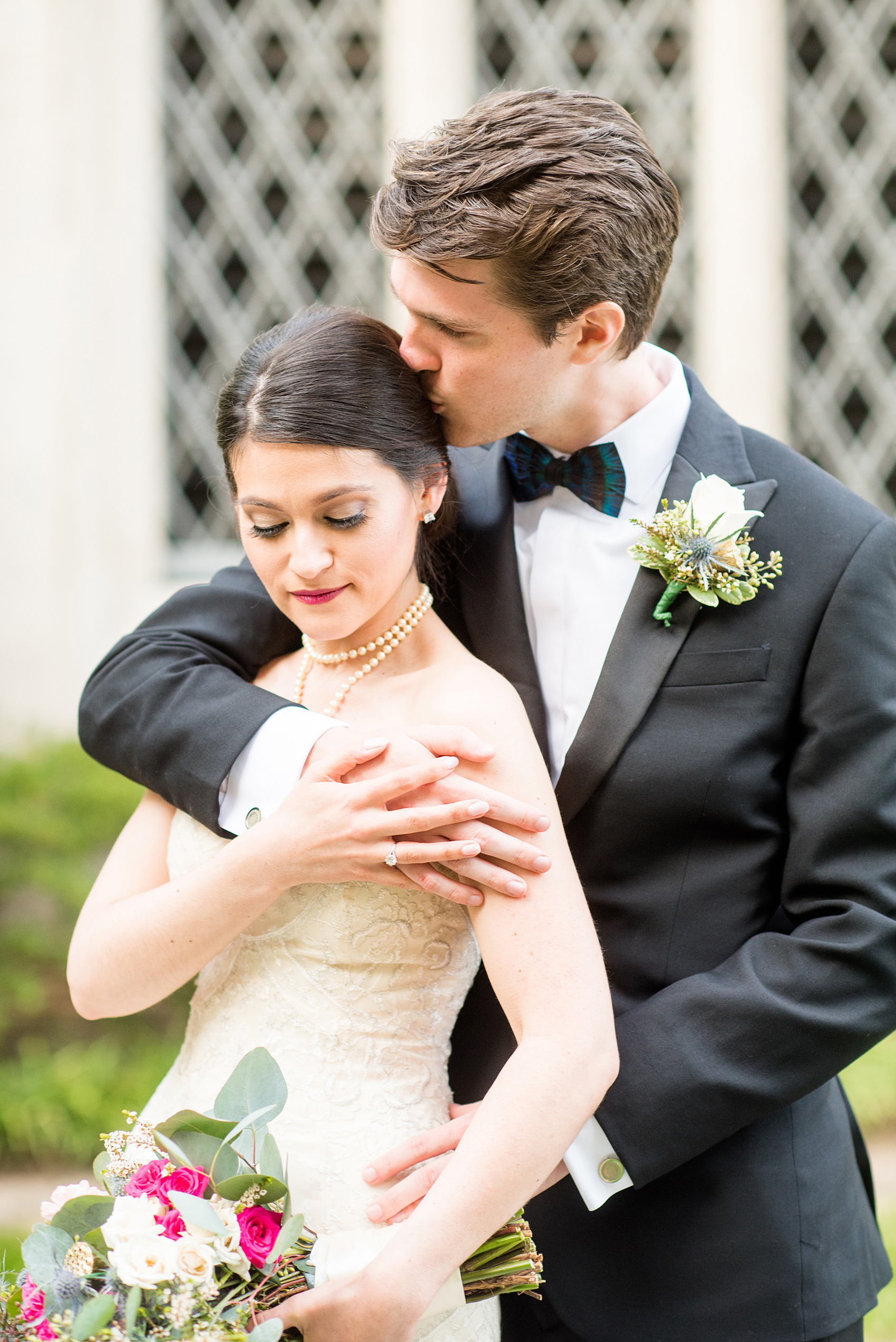 Mikkel Paige Photography photo of a wedding in Chapel Hill at Duke Chapel. Bride and groom with the gothic architecture. A picture of the couple in a black tuxedo strapless sweetheart off-white gown.